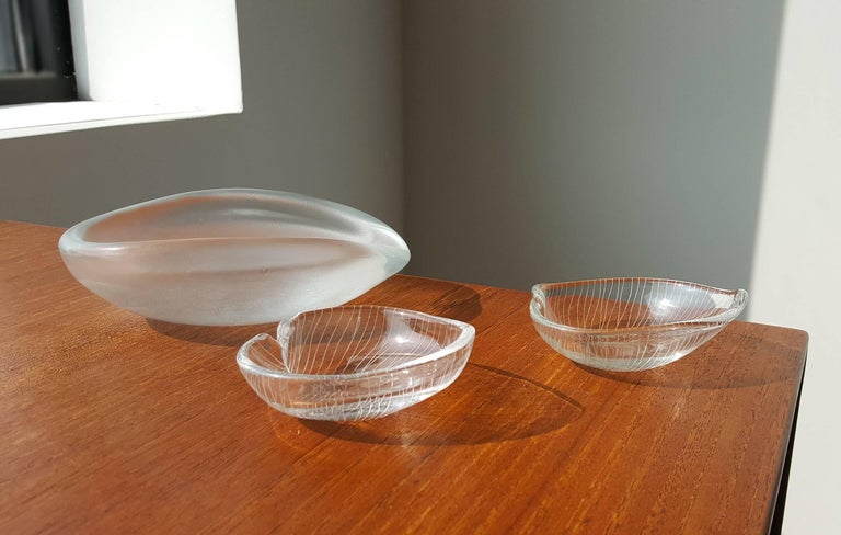 A nice collection of three vintage art objects created by Tapio Wirkkala for iittala. The two smaller leaf bowls have a delicately incised veining and the larger is etched on the top and polished on the underside. All pieces are signed. A lovely