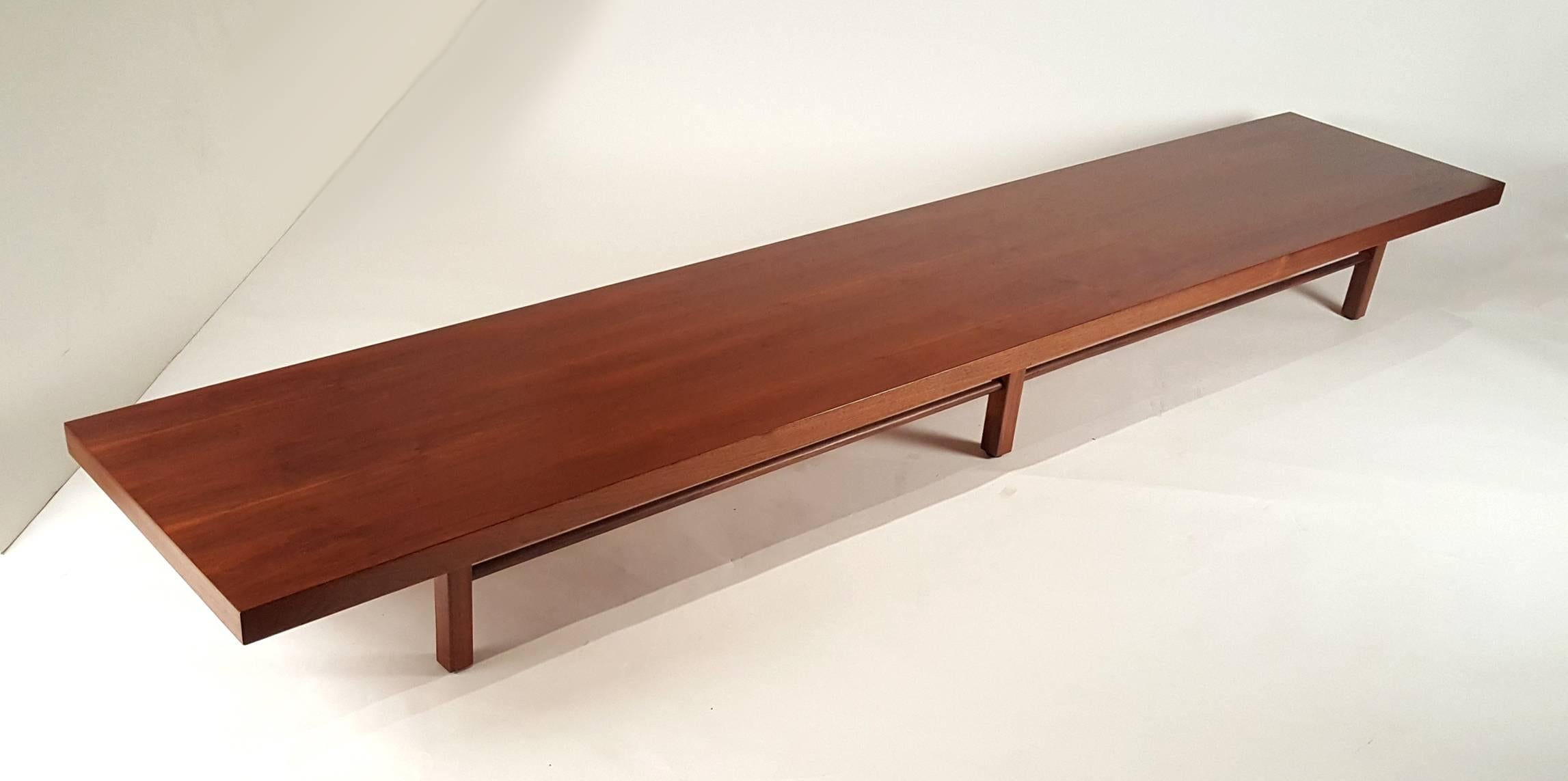 This rare Monumental Milo Baughman table is from his earliest collaboration with Thayer Coggin and retains the original paper label. The sleek, long and low design in the bookmatched walnut is not only visually stunning but also quite versatile. It