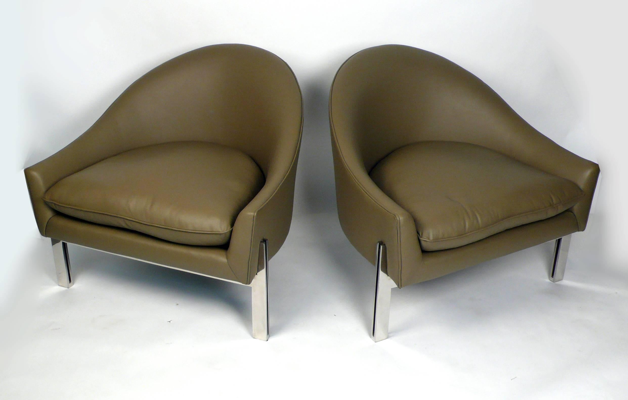 Club chairs designed by Edward Axel Roffman. Chairs are constructed with polished flatbar stainless steel construction with new Spinneybeck leather upholstery. Excellent condition.