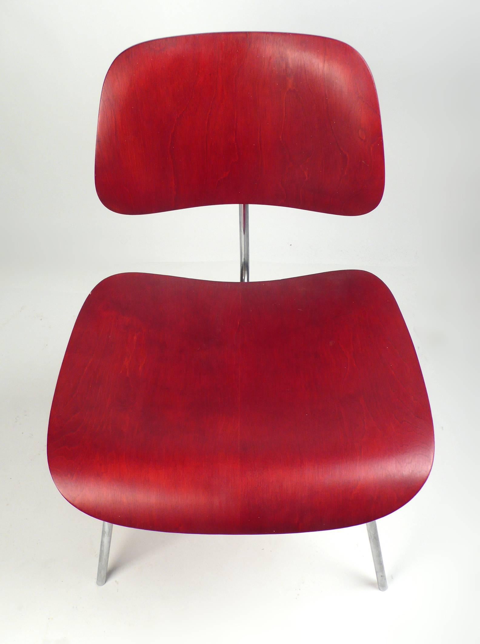 Early Production red analine dye DCM designed by Charles Eames manufactured by Herman Miller. Chair is in very good original condition.