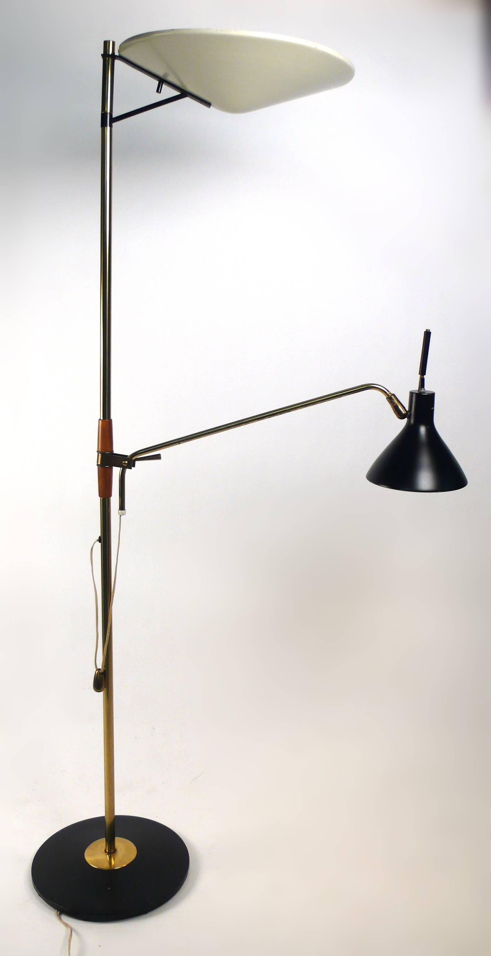 Floor lamp designed by Gerald Thurston for Lightolier. Lamp has adjustable reading lamp, swiveling uplight and original brass counter weight. Base measures 11
