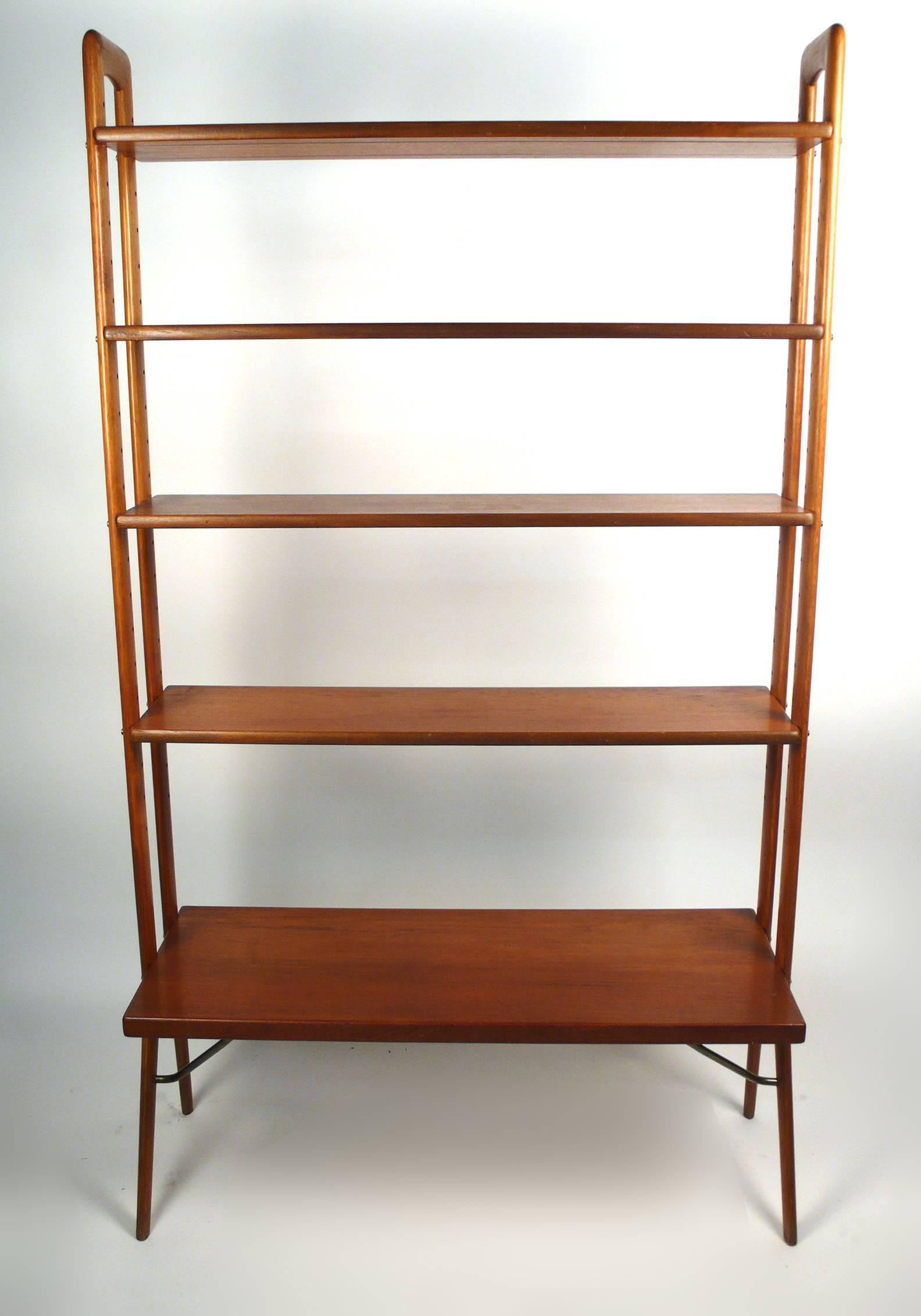 Freestanding Danish modern bookshelf designed by Kurt Ostervig. Adjustable teak shelves and solid oak uprights.