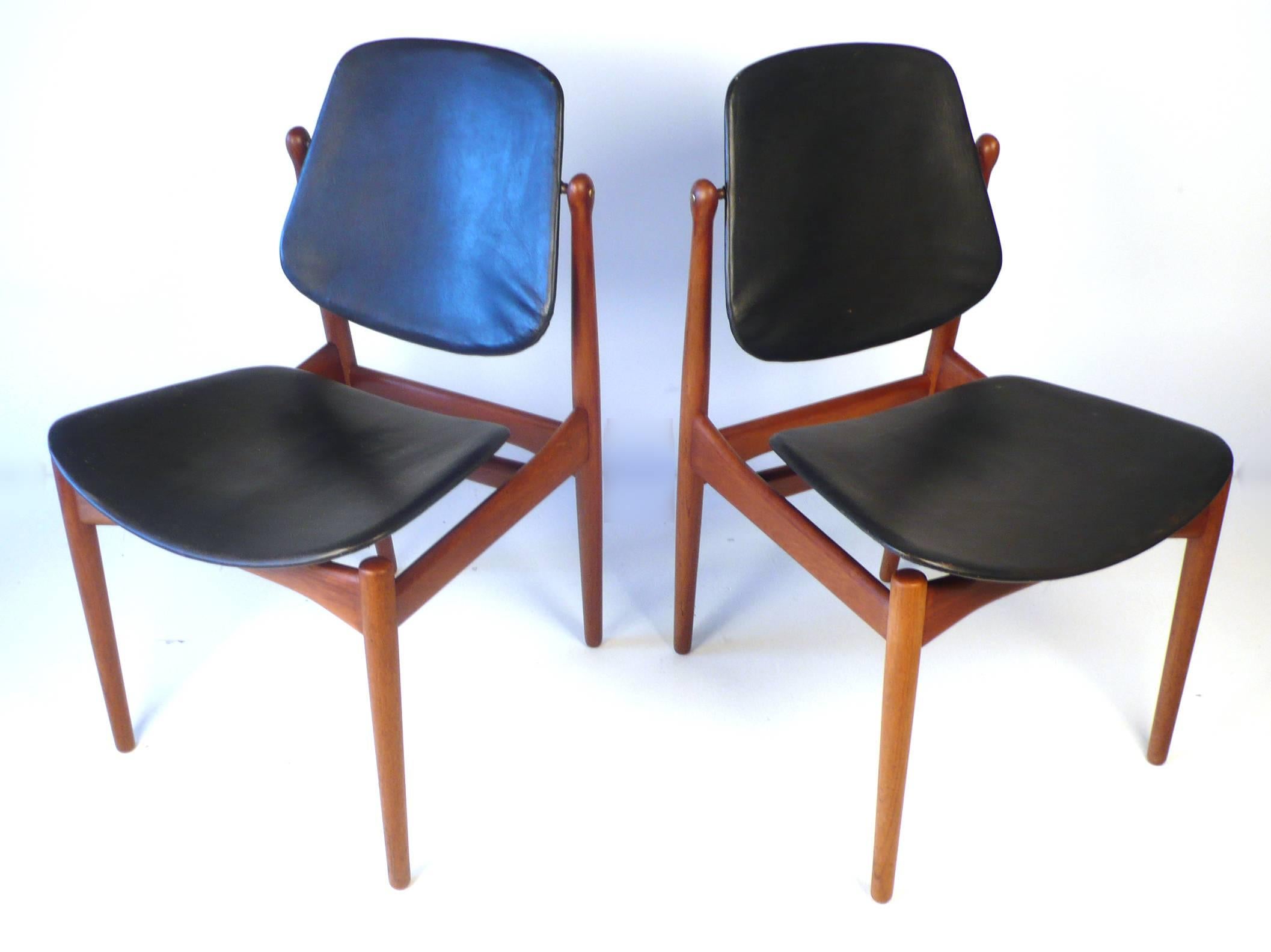 Six Danish modern Arne Vodder solid teak dining chairs manufactured by France and Son of Denmark. These are thought by many to be the best of Vodder's dining chair designs. Signed with brass medallions and embossed insignia. The tilting backs cradle
