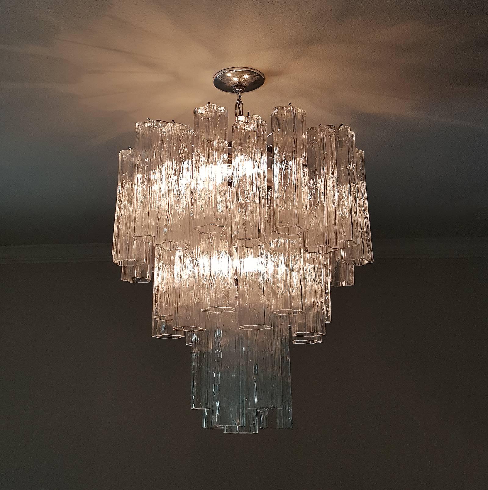 This elegant Italian Murano glass chandelier is comprised of three-tiers of handblown glass elements that resemble the shape of snowflakes. The nickel finished fixture is in very good condition and all of the glass elements appear to be in excellent