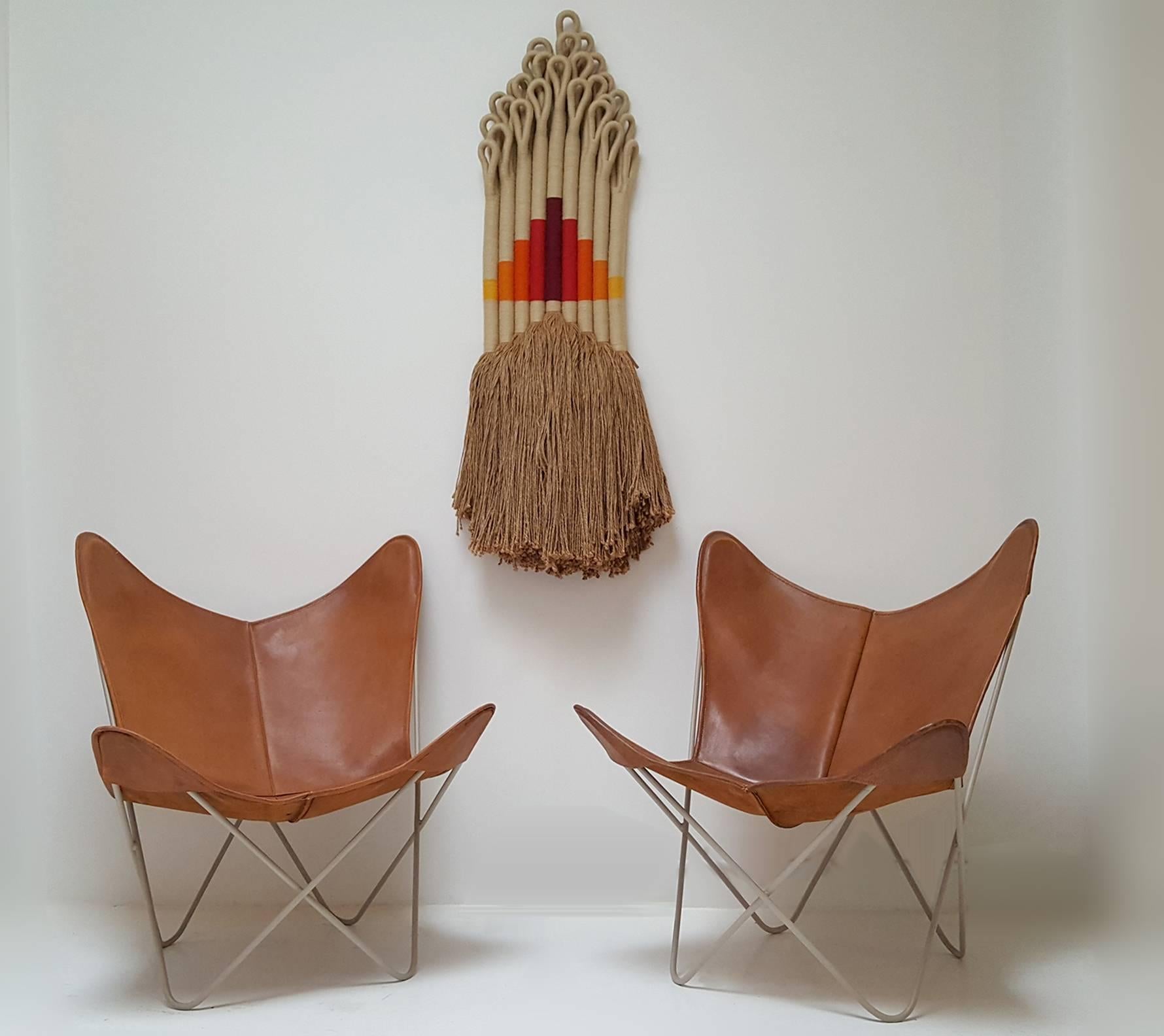 Early pair of Knoll Hardoy butterfly chairs with beautiful original patinated cognac leather slings. Frames powder-coated in a matte Khaki paint to compliment the slings. Suitable for indoor or outdoor use.