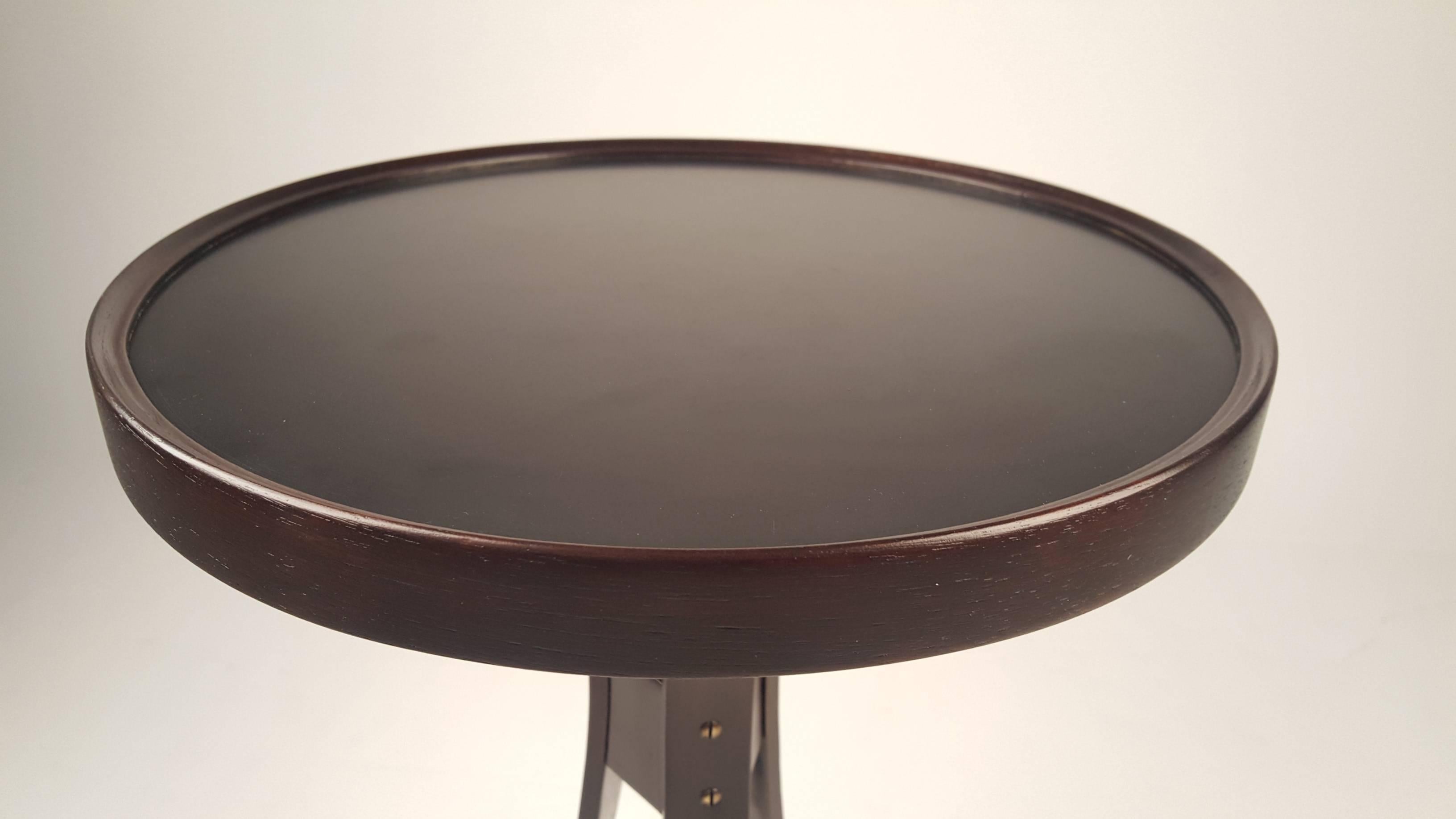 Side table by Roger Sprunger for Dunbar. Very graceful, has slightly raised edge on top. Fully refinished and in excellent condition. Black laminate top.
