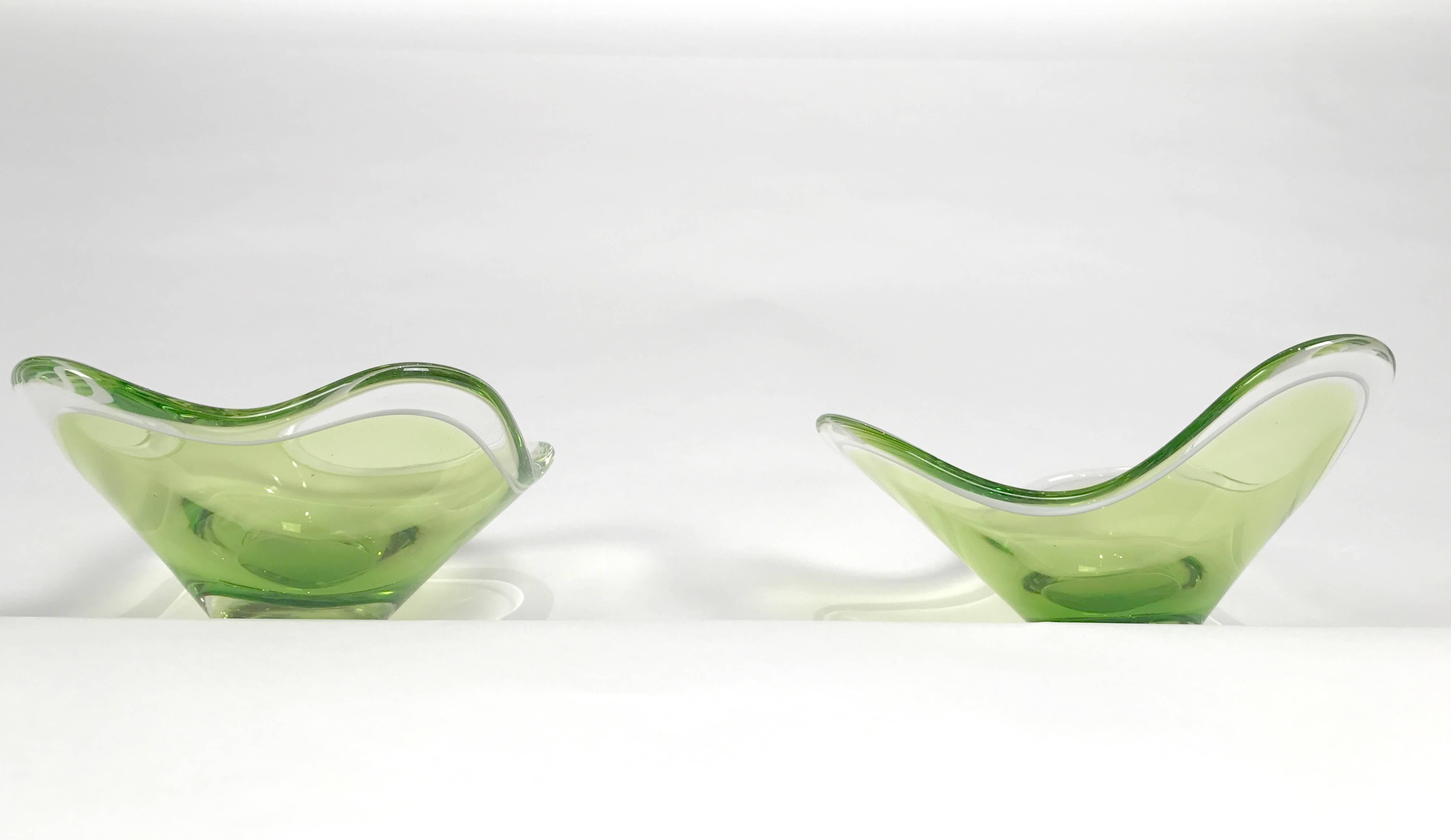 Two beautiful matching glass bowls, one three lobe and one four lobe designed by Paul Kedelv for Flygsfors. Both pieces are in excellent condition and signed Flygsfors, Kedelv, circa 1955.

 Paul Kedelv 1917-1990, worked for Flygsfors in Sweden