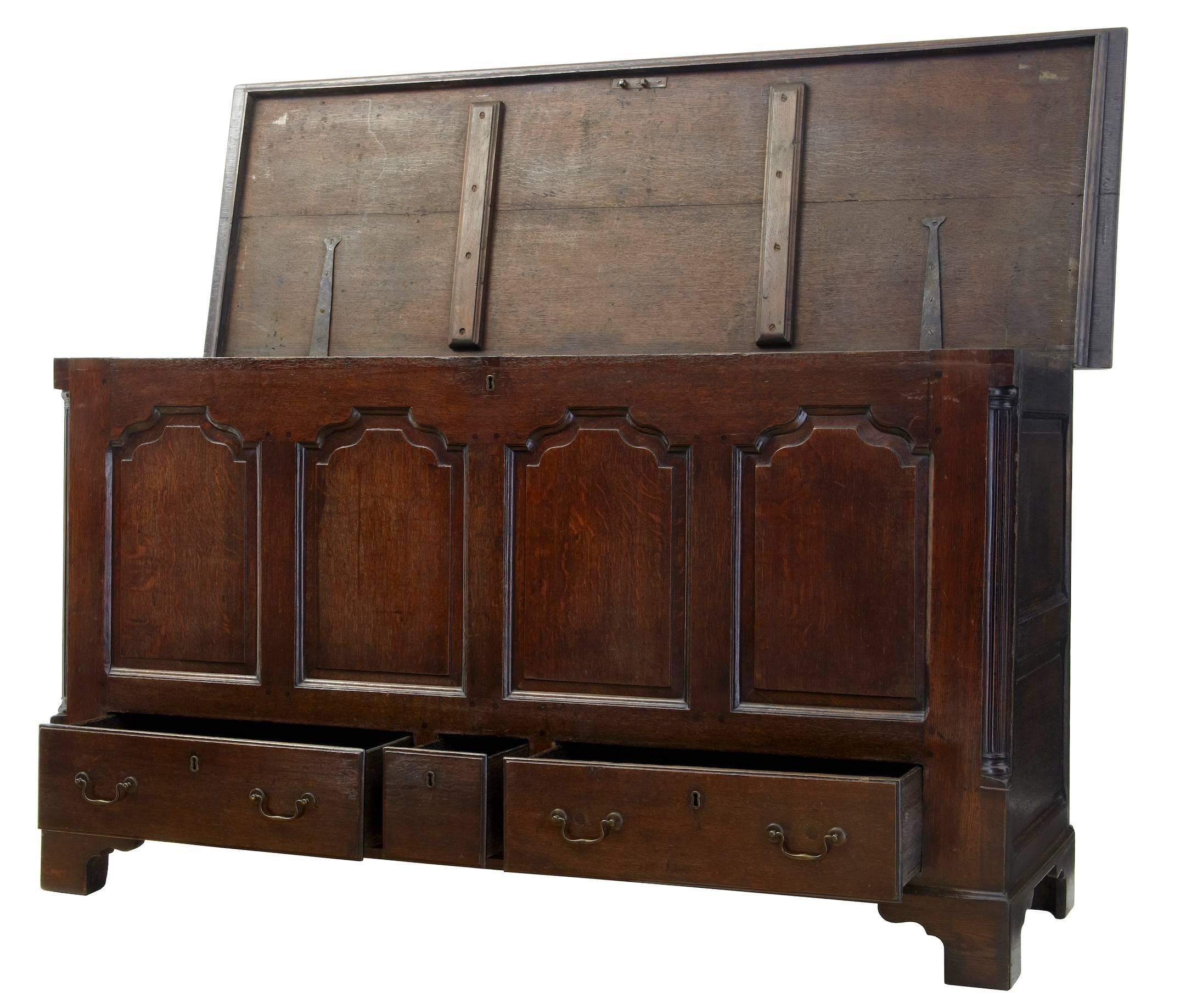 Fine Lancashire oak mule chest or large proportions, circa 1770.
Three drawers to the base with later swan neck brass handles.
Original hinges with brake on the reverse to stop the lid from over extending.
Four paneled front.
Standing on bracket