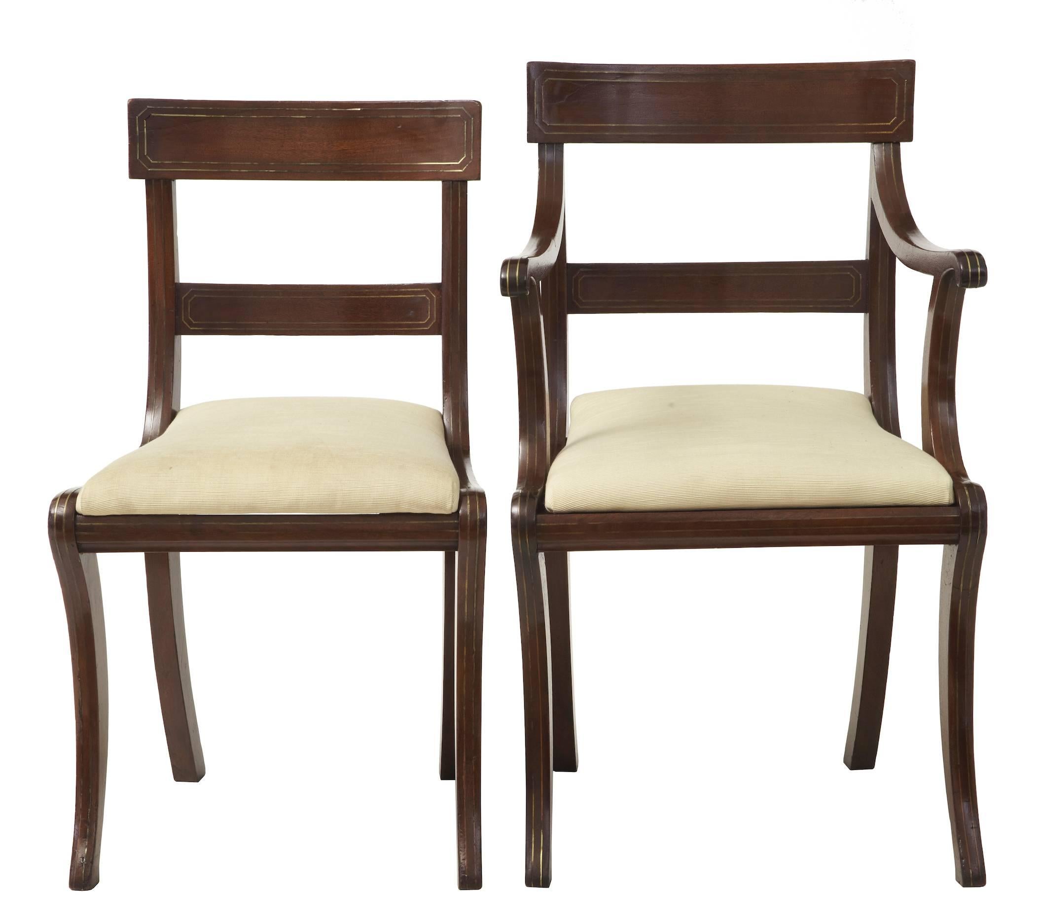 Good quality set of chairs, circa 1920.
Made in the Regency taste with scrolled arms, shaped backs.
Inlaid with double brass lines to all front facing surfaces.
Some minor losses to brass and replacements.

Armchair measurements:
Height
