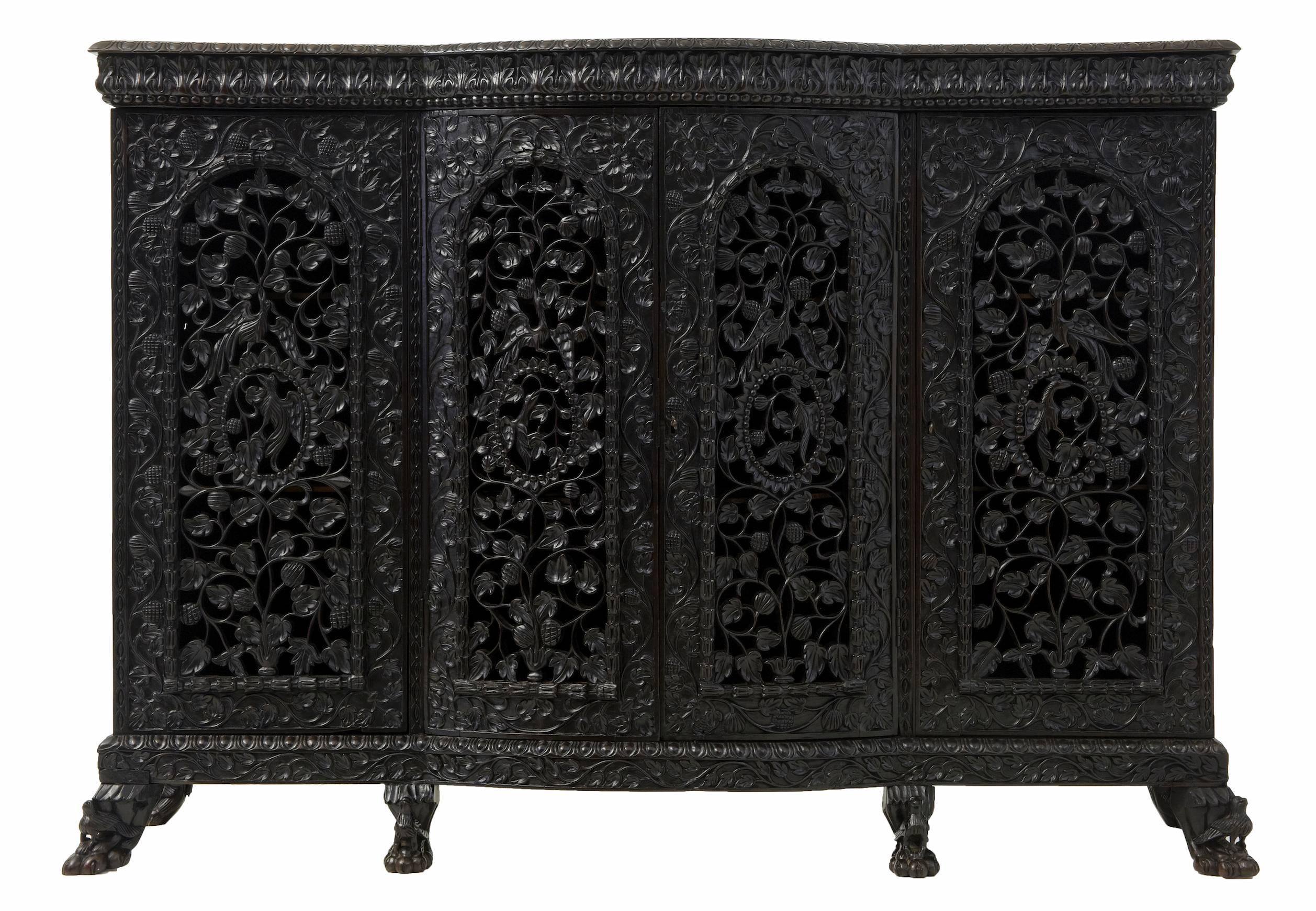 Superb quality Anglo Indian breakfront cabinet circa 1840.
Central double door cupboard with 2 shelves flanked either side by single door cupboard with 2 shelves.
Profusely pierced and carved front doors depicting birds and flowers.
Carved sides