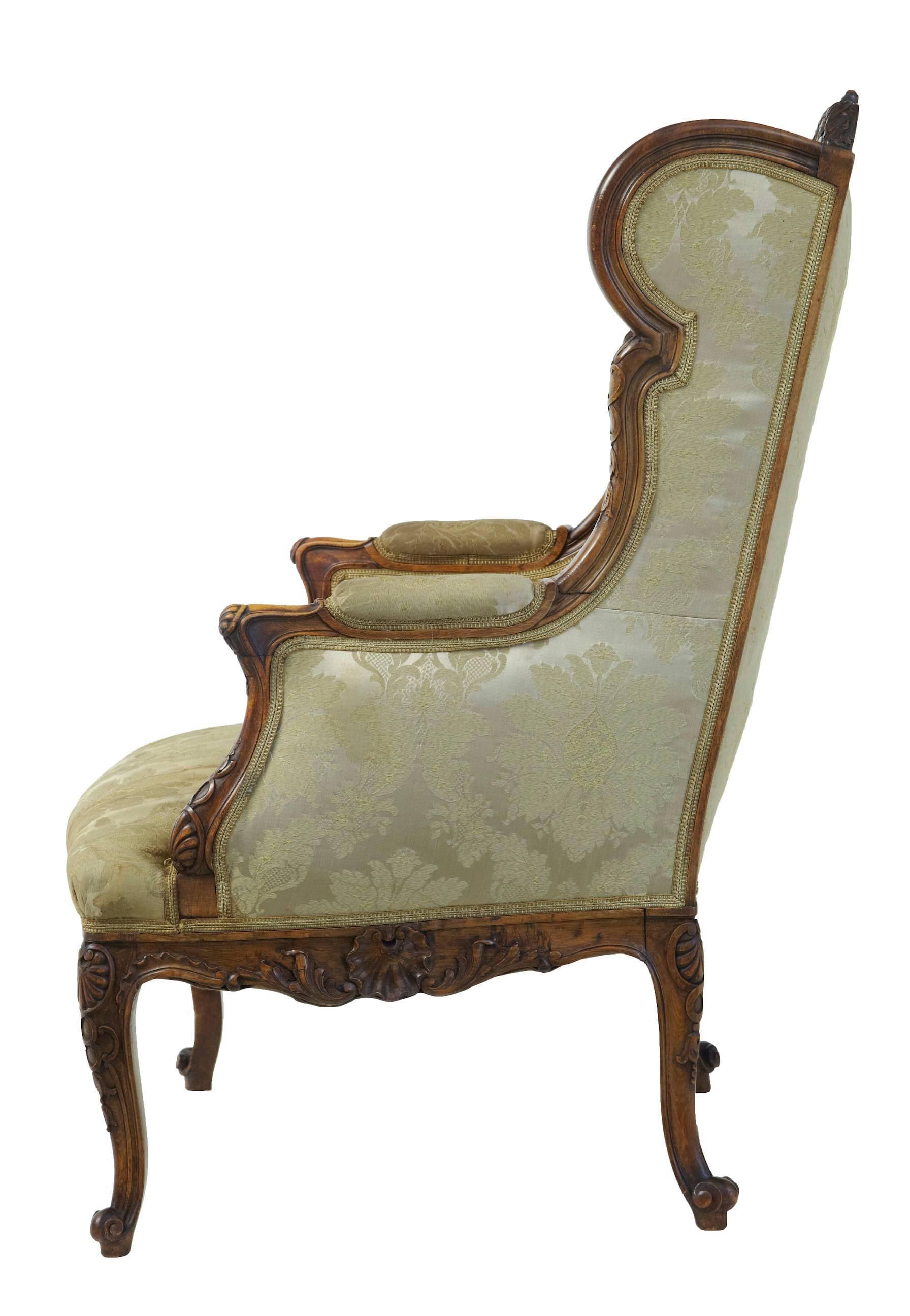 Beautiful carved wingback french armchair circa 1870.
Carved with shells to the back, arms and legs.
Some staining to fabric on the seat which would need a deep clean.

Height: 43