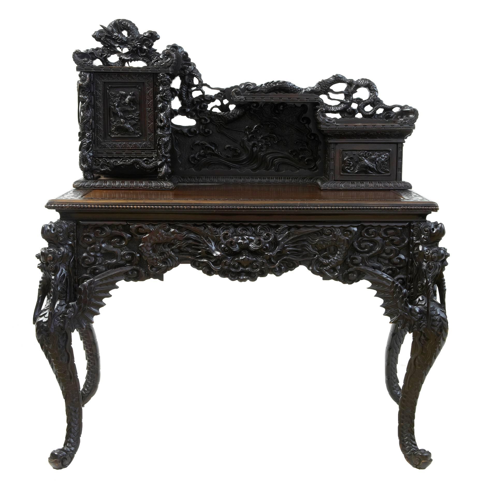 Stunning carved desk possibly Japanese circa 1900.
Good quality desk, comprising of 2 parts.
Top with heavily carved single door to the left containing pigeon holes and a drawer. A single drawer to the left with pagoda roofs, surmounted by a