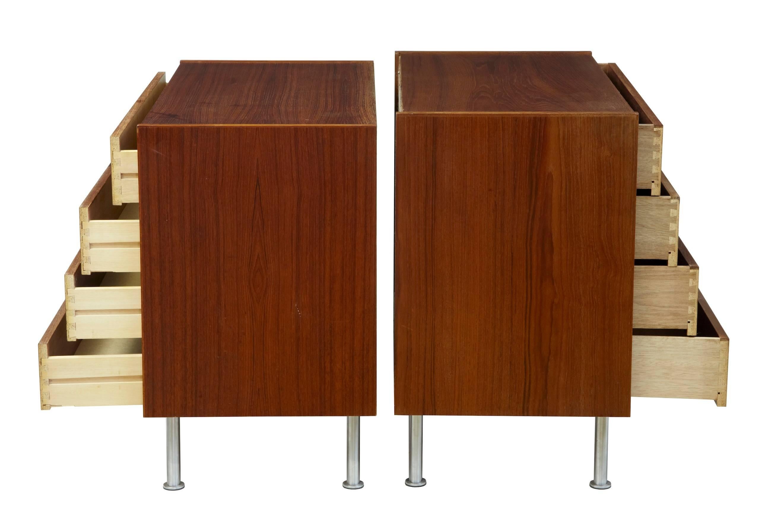 Very near pair of teak chest of drawers, circa 1970.
Four-drawer modern design chests, with recessed wooden handles.
Standing on tubular legs.
Some marking and staining to surfaces.

Measure: Height 27 1/4