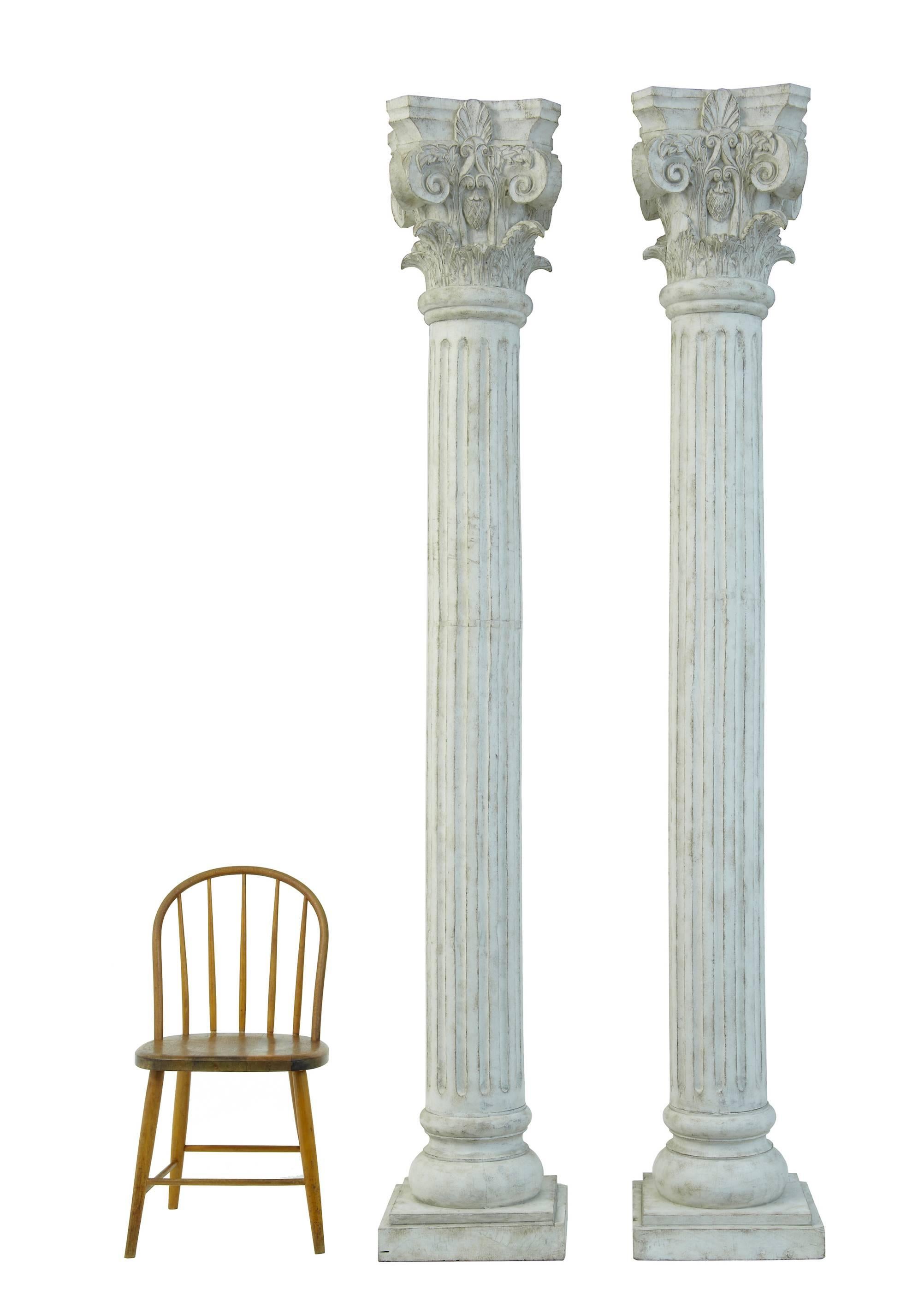 Impressive pair of carved decorative columns which are over 8 foot tall.
Excellently carved and colored to imitate stone.
Corinthian top with fluted column.
Ideal for creating feature statement pieces.

There is a chair alongside in 1 picture