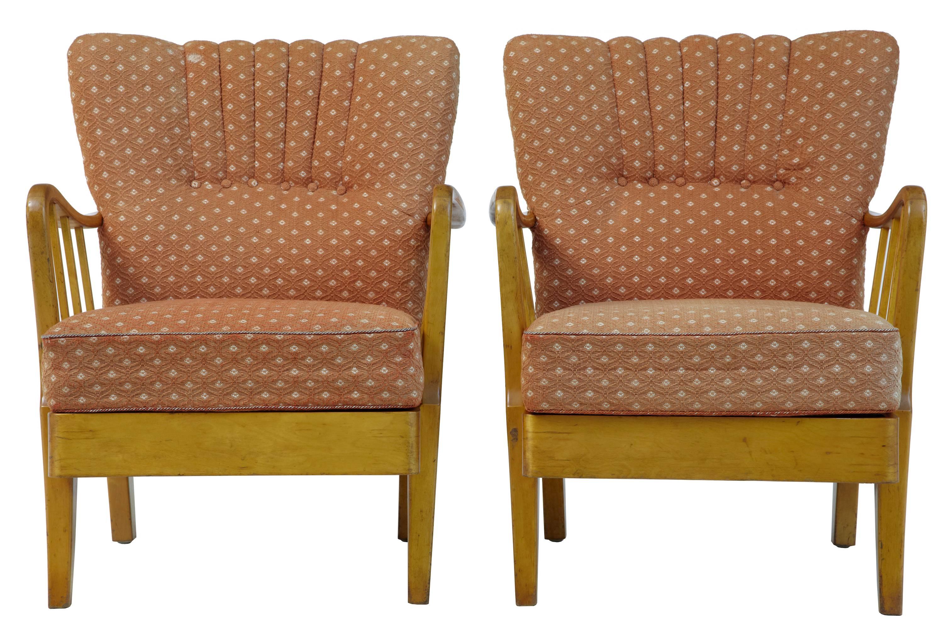 Pair of 1950s Swedish easy chairs.
Scalloped shaped backs.
Open spindle arms.
Original upholstery in good condition, but faded.

Measures: Height: 32 1/4