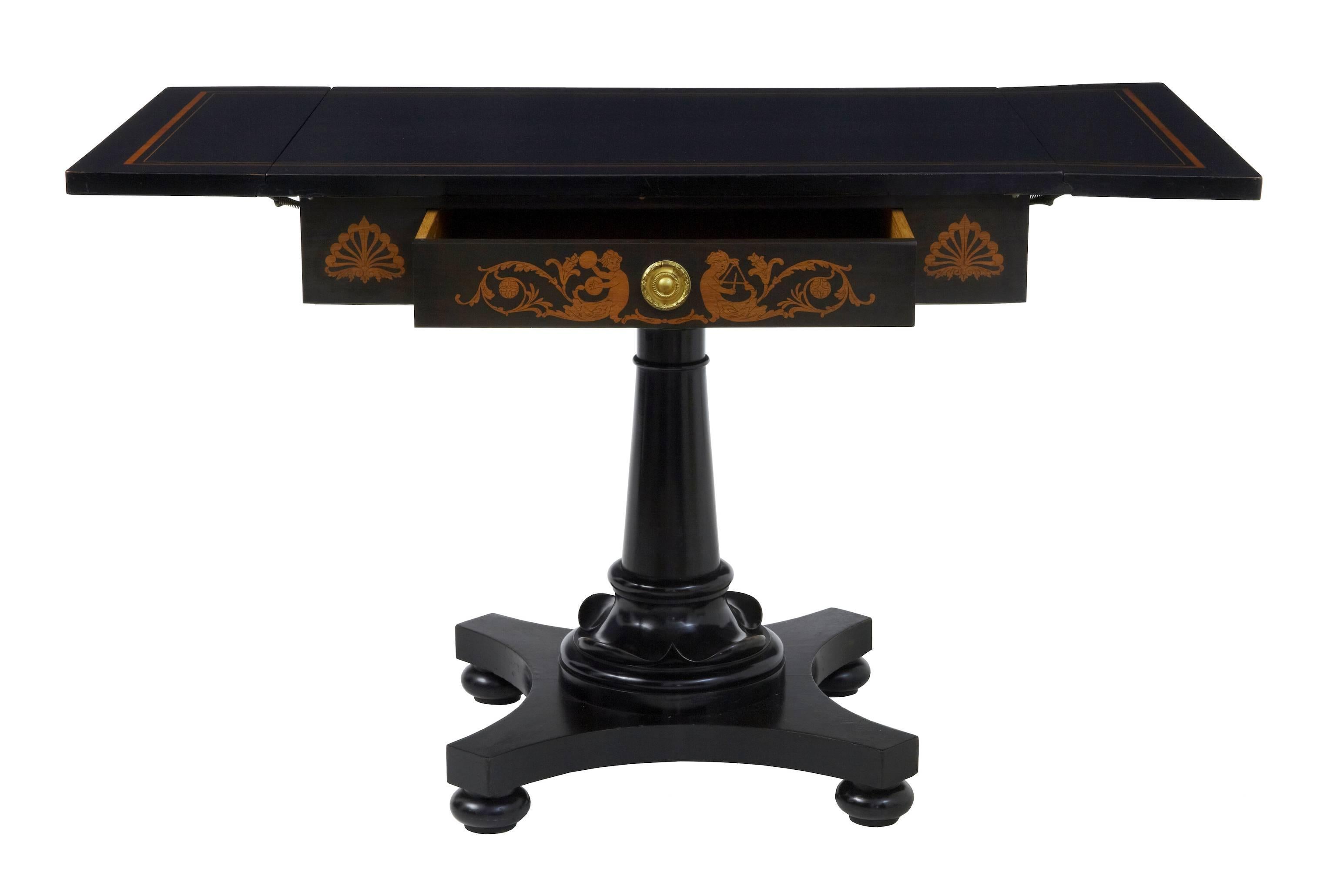 Swedish ebonized table, circa 1890.
Drop-leaf sofa table with inlaid top and drawer.
Single drawer to front.
Some minor rubbing to ebonised finish.

Measures: Height 29 1/2