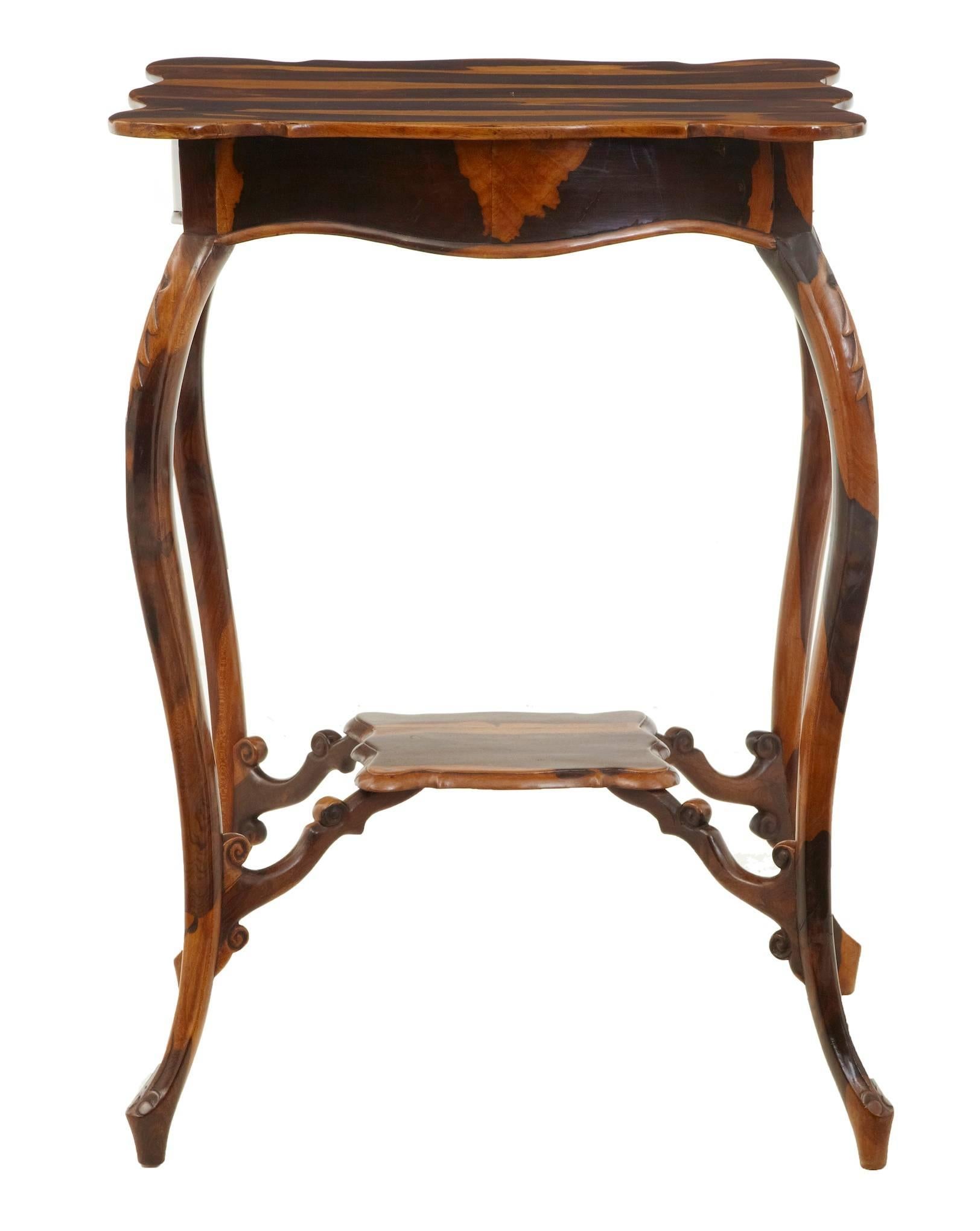 Rare and unusual table made from cordia wood, circa 1840.
Probably a unique table, made with striking cordia wood veneers on the top and carved legs in the solid.
Shaped top with a second tier support between the legs.

Some age splits to the