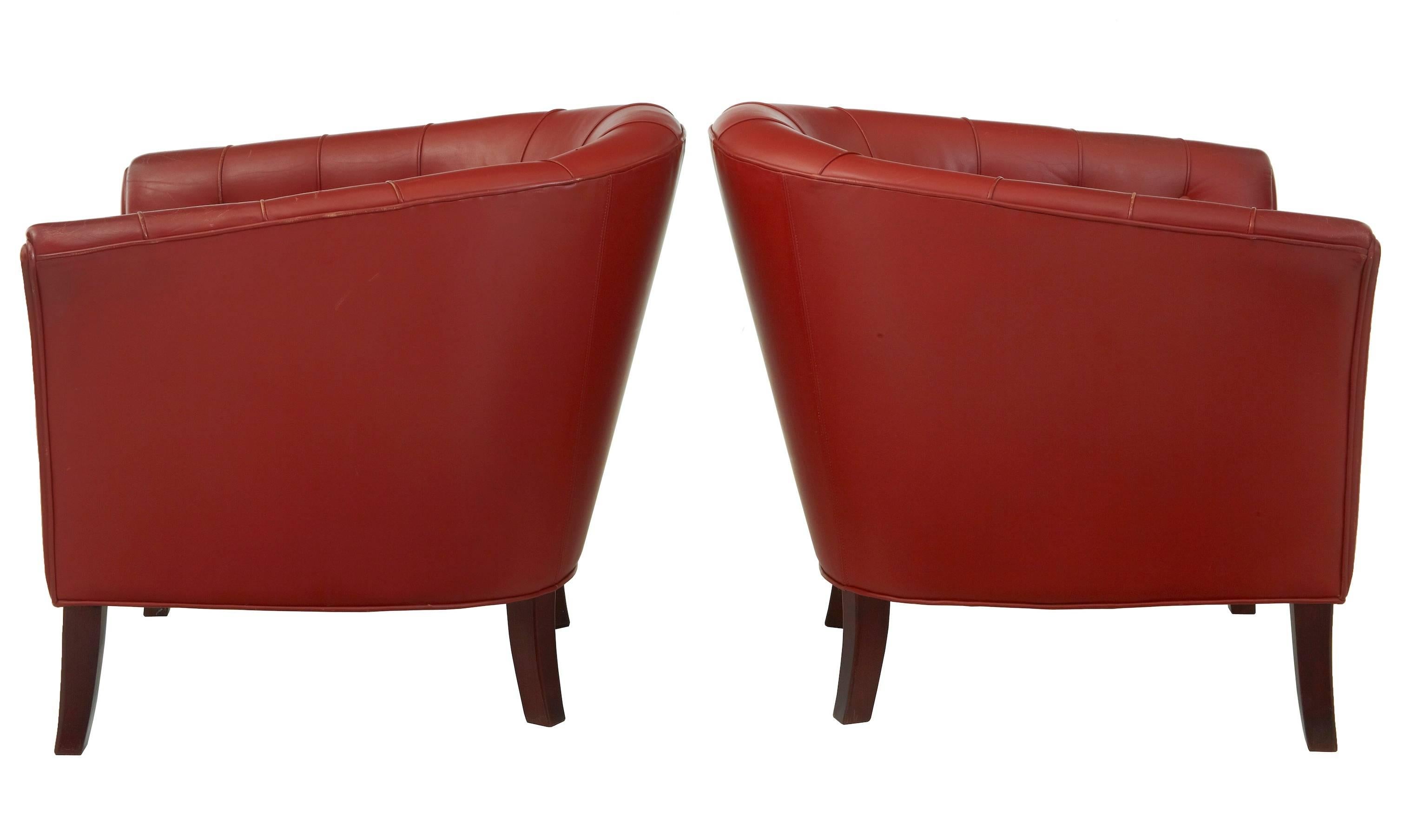 Fine quality leather lounge club armchairs.
Upholstered in rusty red leather.
Mahogany colored tapering legs.
Very comfortable and stylish.

Minor wear to arms, minor scuffing to reverse.

Measures: Height: 28