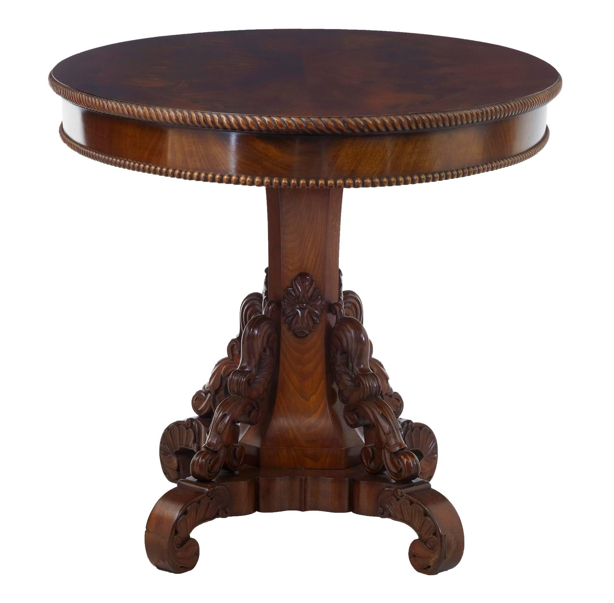 Stunning center table with flame mahogany top, circa 1880.
Oval top with gadrooned and beaded edging.
Beautifully carved foliage leading down the shaped base.
Good rich color.

Minor veneer crack (pictured)

Neasures: Height 29 1/2