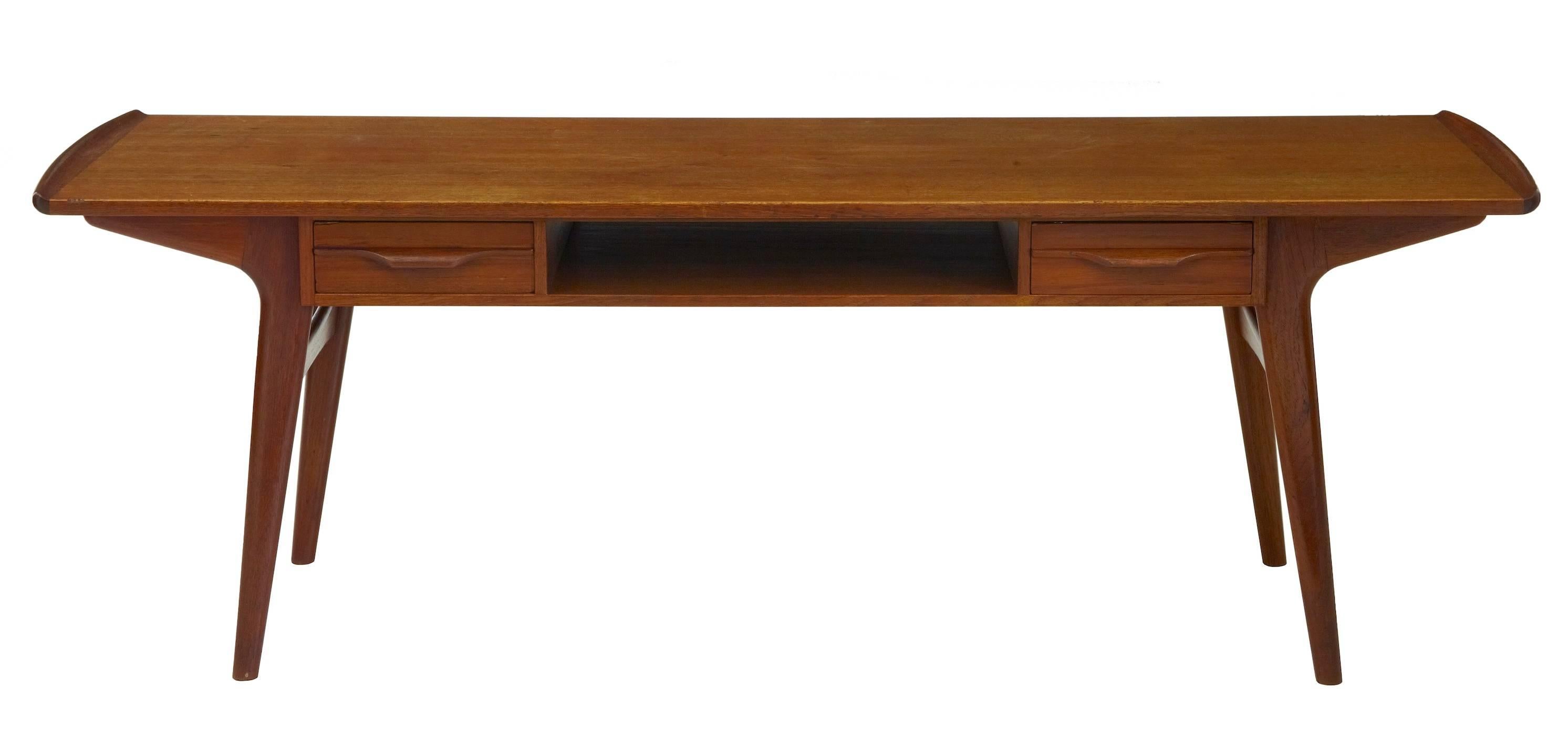 Scandinavian teak low coffee table, circa 1960.
Two drawers which push through both sides and a open aperture.
Marks to top.
 