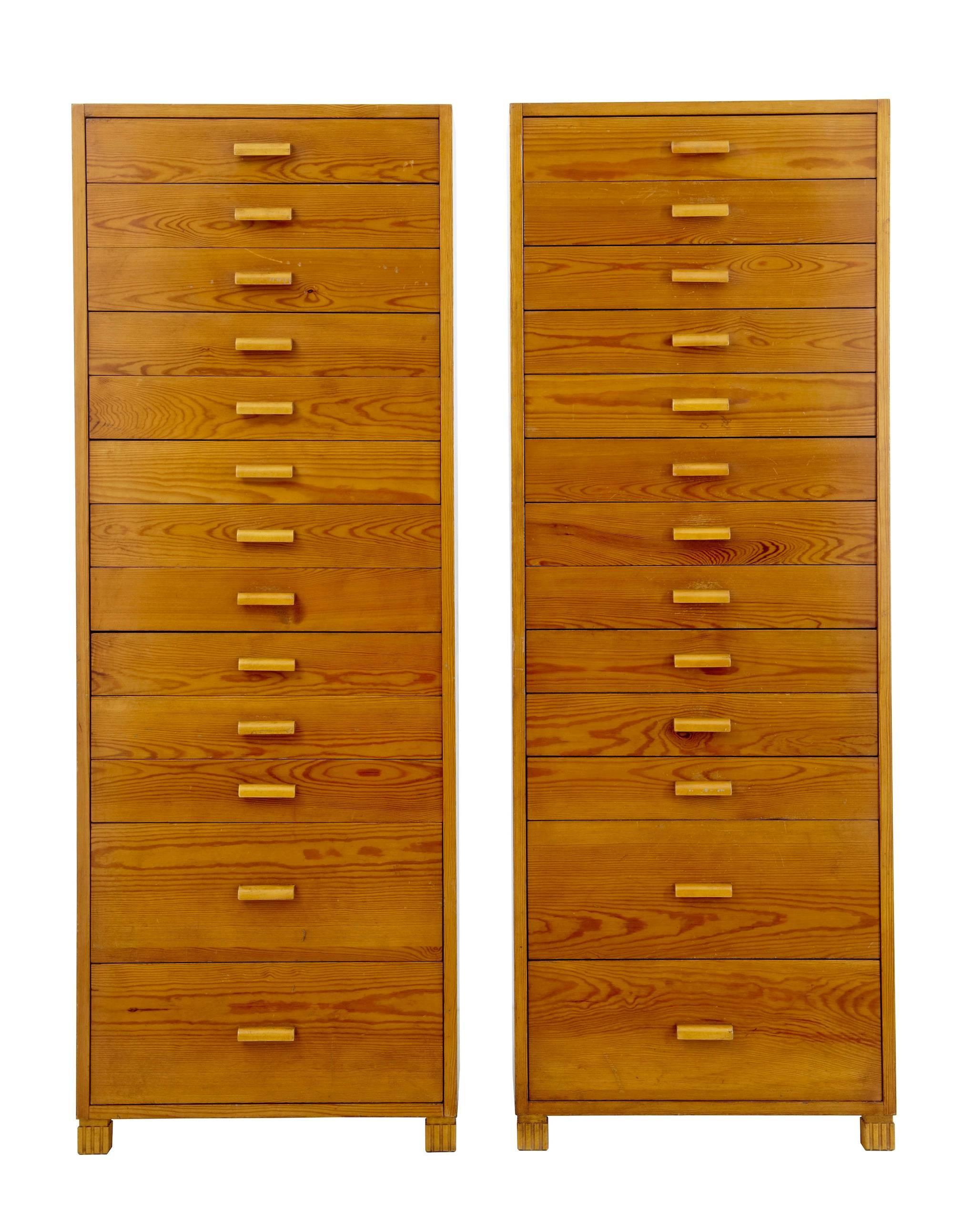 Fine pair of pine tall chests circa 1950.
13 graduating drawers in each.
Rich golden colored pine.

Some surface marks to fronts and sides, but could be restored if undesirable in current condition.

Measures: Height: 65 1/3