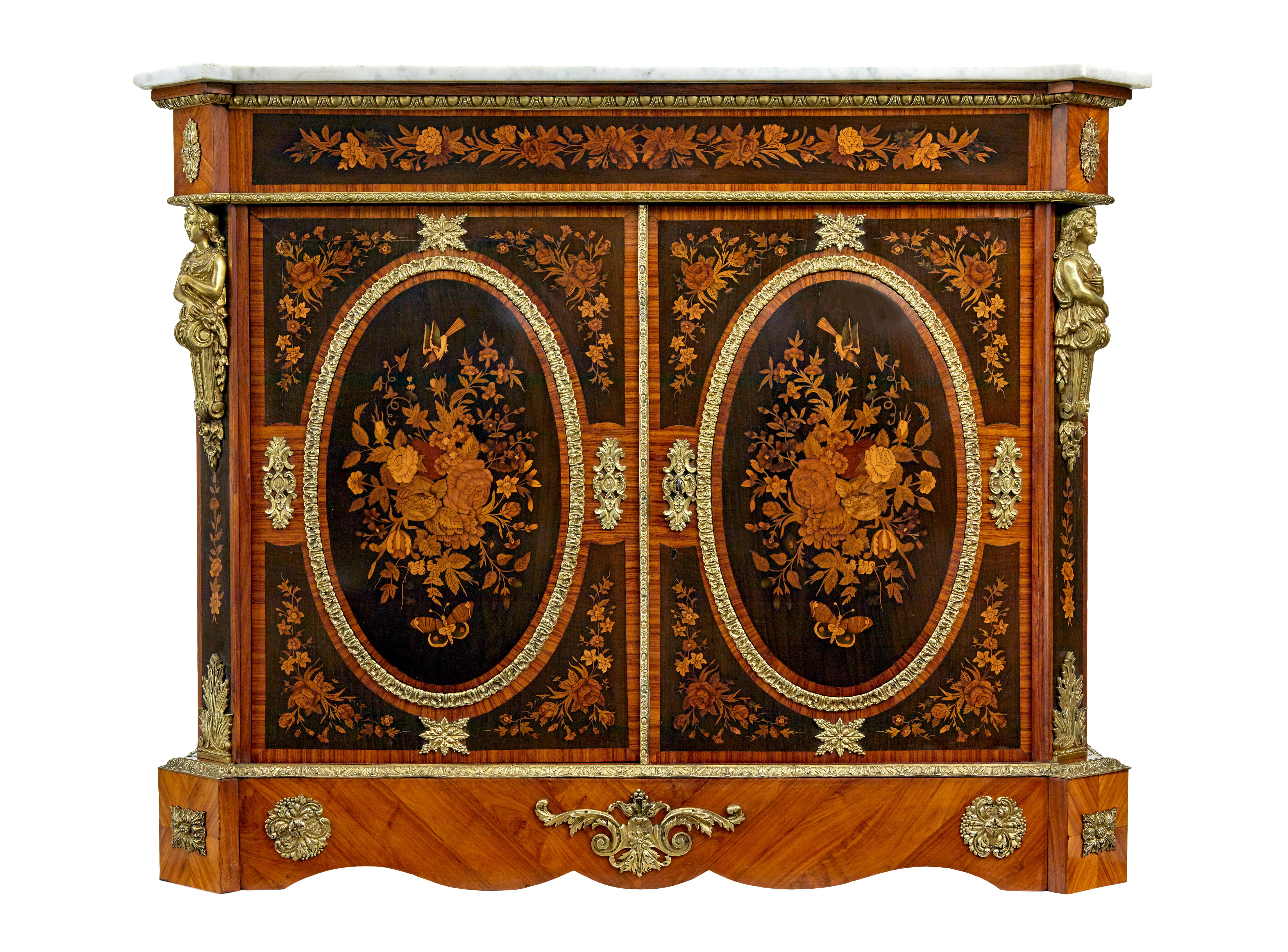 19th century French ormolu-mounted marquetry meuble d'appui circa 1880. Marquetry in the manner of of earlier furniture maker Joseph Cremer.

Eared rectangular white marble top sits above a frieze decorated with a foliate spray. Panelled double