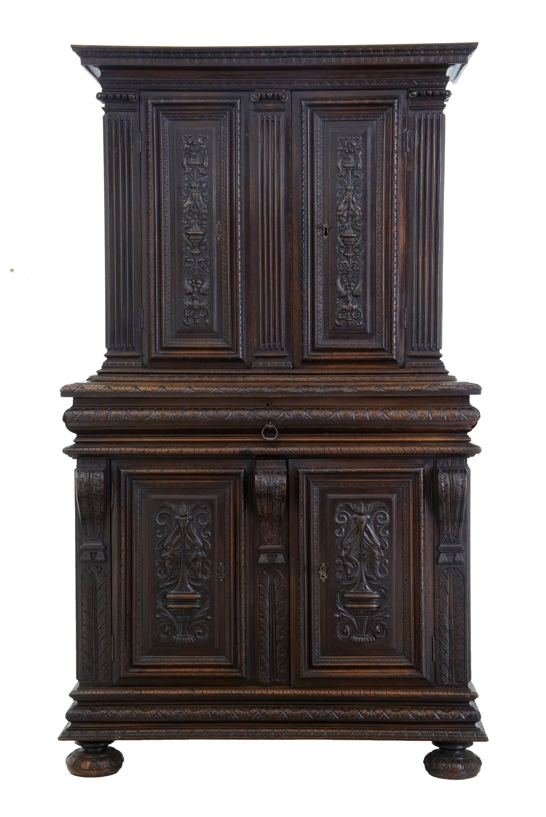 Two-part carved walnut cabinet, circa 1850.
Top section of beautifully carved double doors, flanked by columns, surmounted by cornice. Opens to reveal single shelf inside.
Bottom section comprises of a large drawer below which the double doors