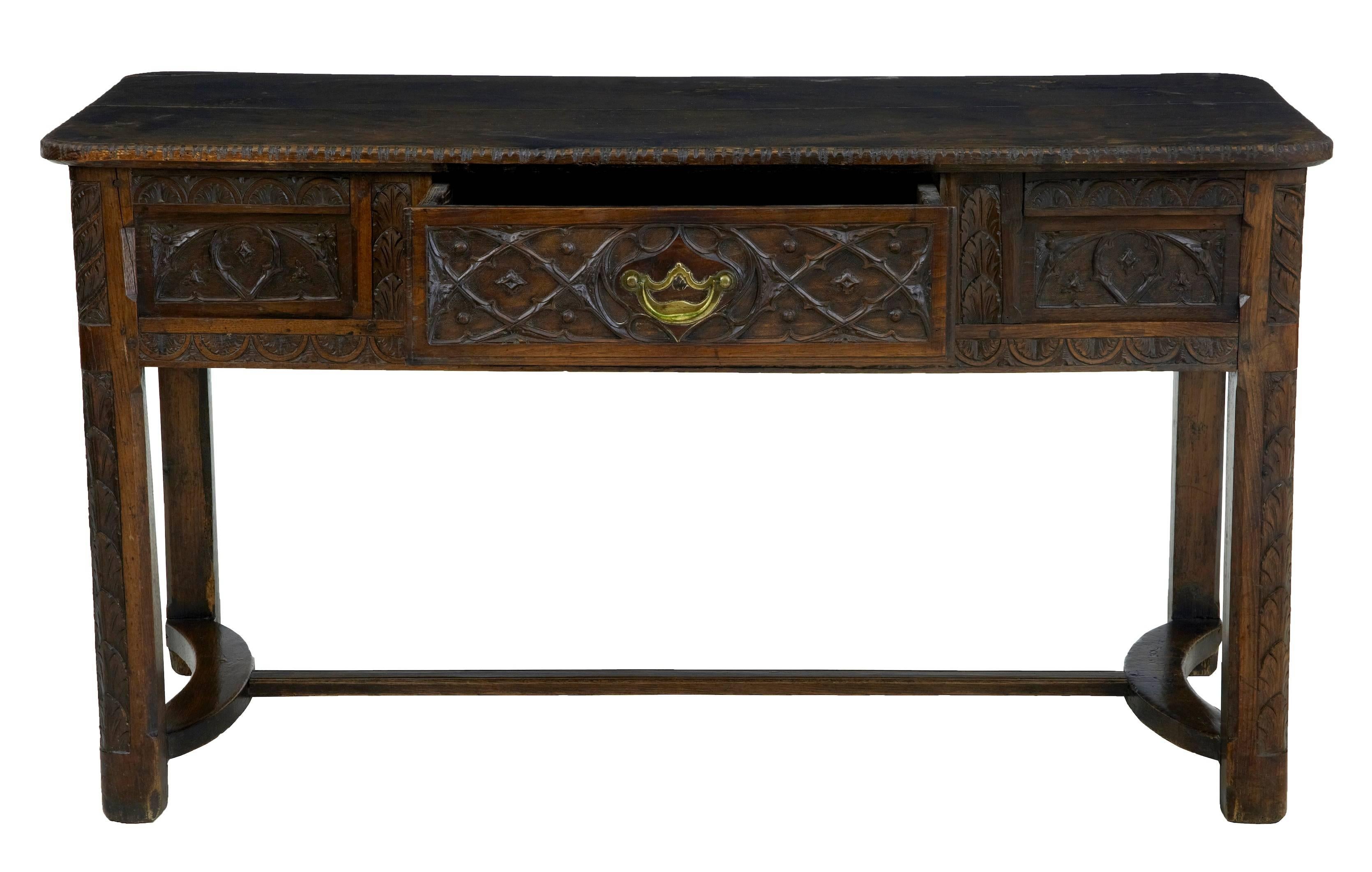 Fine quality French oak table, circa 1820.
Excellent quality tracery and level of carving, which carries on around this piece making it free standing. Single drawer to the front with later handle.
Carved legs united by later central