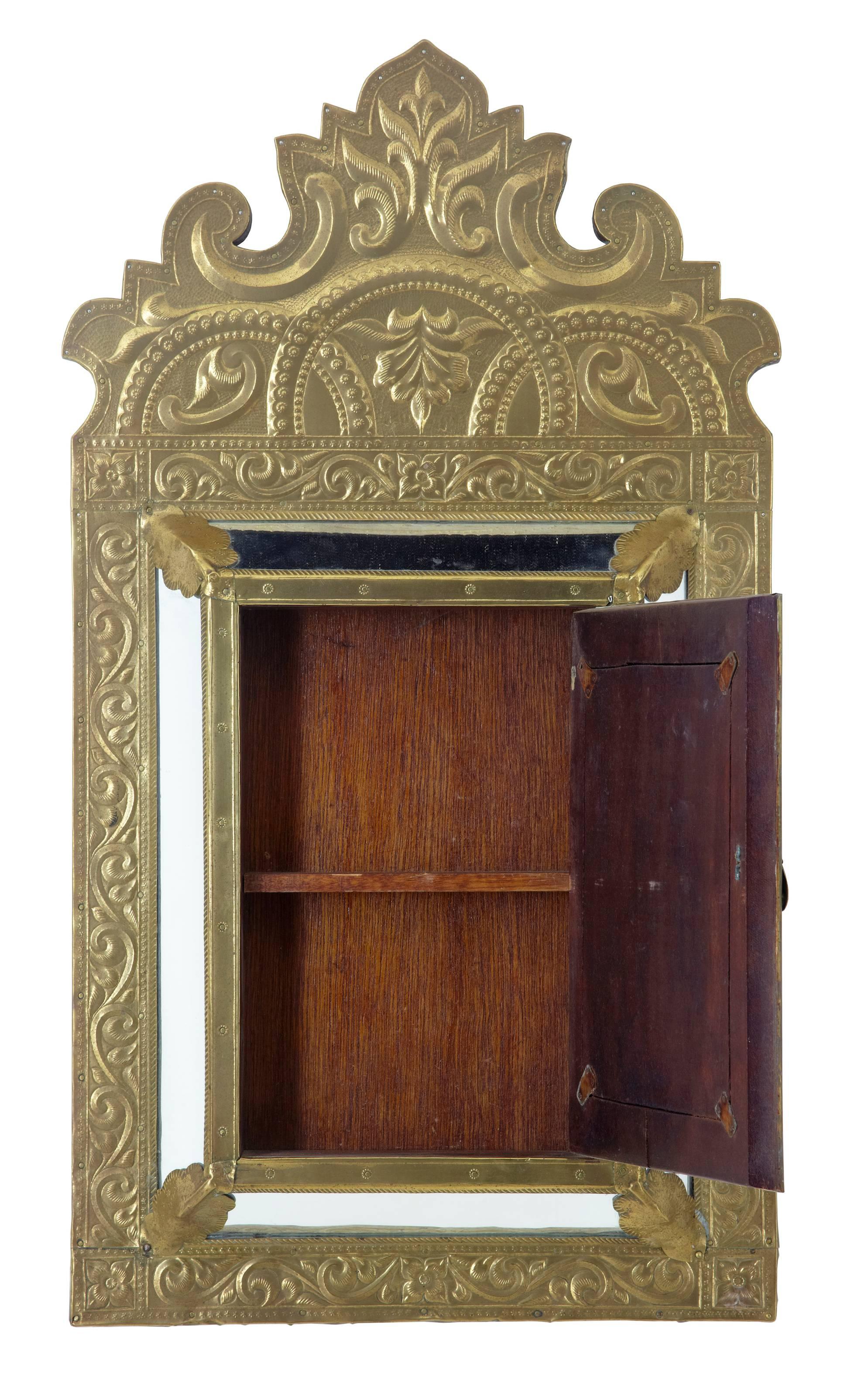 Good quality Art Nouveau brass mirrored cabinet, circa 1890.
Small central mirrored door opens to reveal a small interior with one shelf. Ideal for a key cupboard or medicine cabinet.

Measures: Height 25