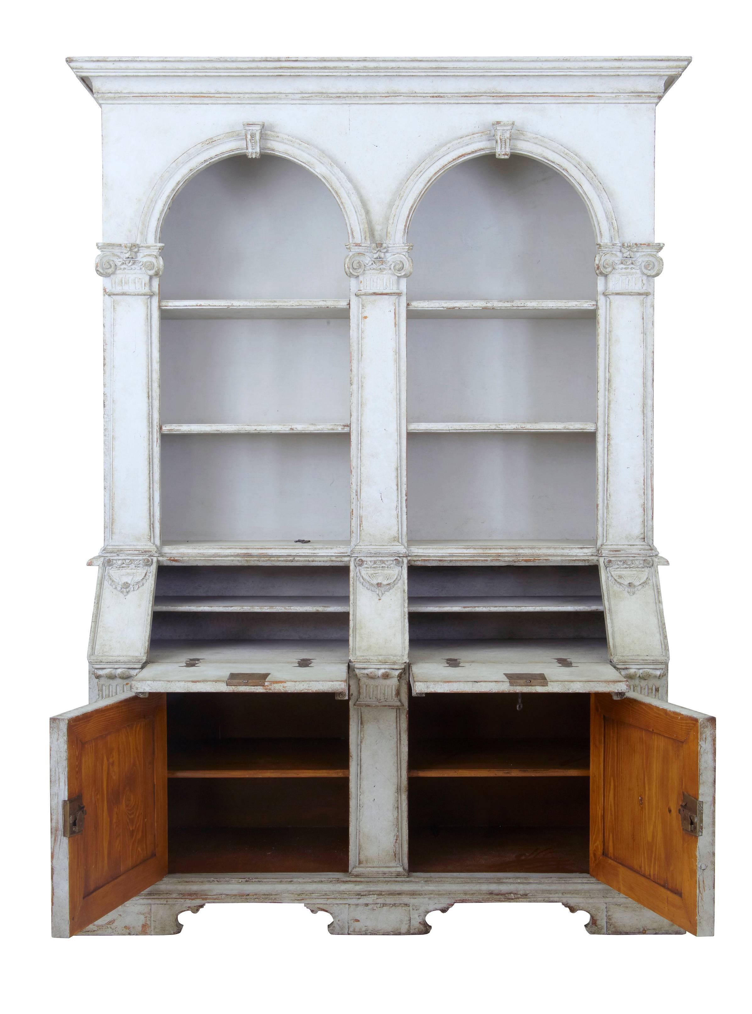 Impressive architectural rare Renaissance Revival double bureau bookcase, circa 1950.
Comprising of two parts.
Top section with two domed recess' containing two shelves in each, flanked either side by columns.
Bottom section comprising of two