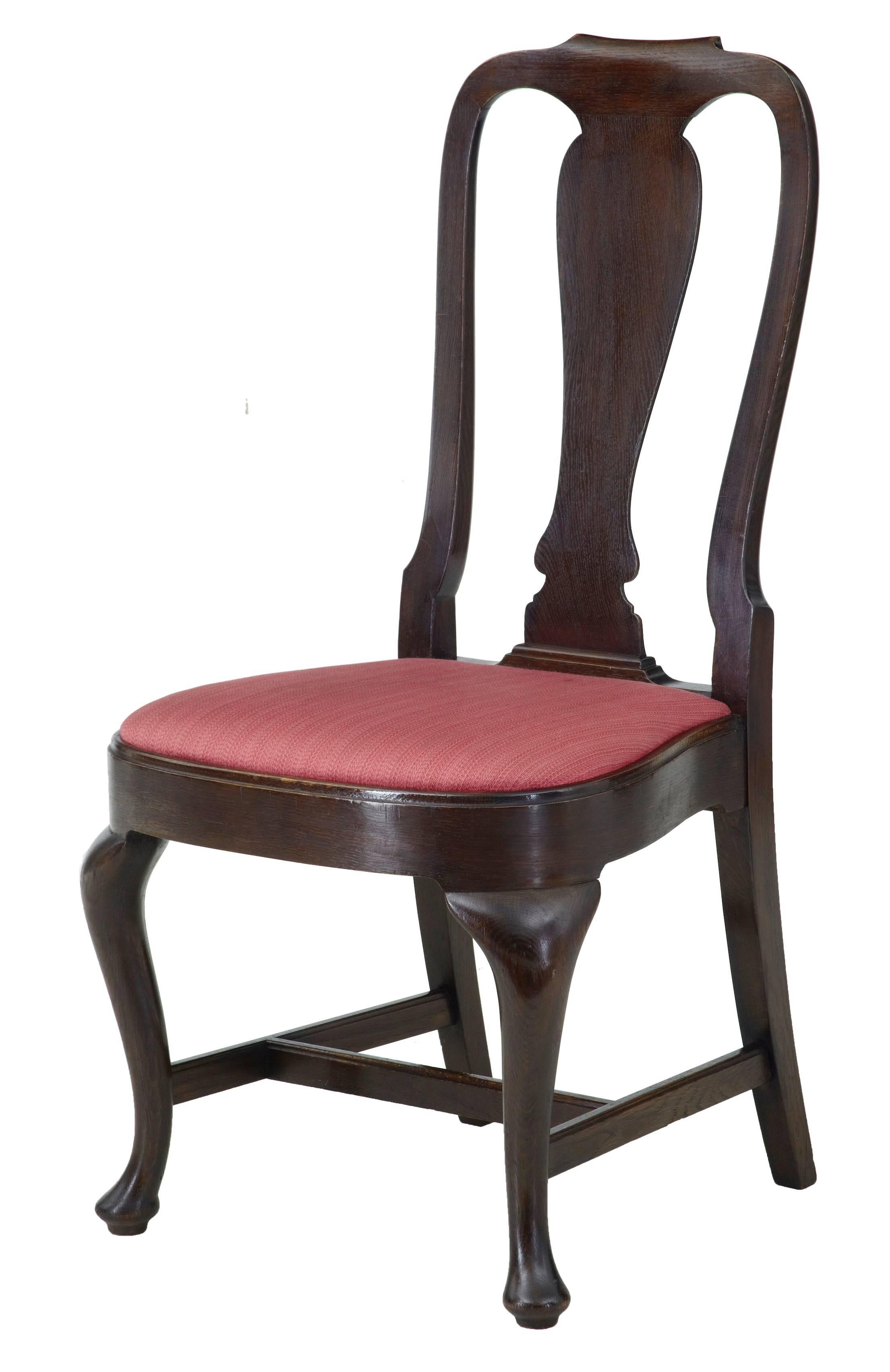 Rare set of 12 fine oak dining chairs from the 1920s.
Made from a Queen Anne design.
Cabriole front legs terminating on pad foot.
Seat inserts would benefit a clean, but in respectable condition.

Measures: Height 39 1/4