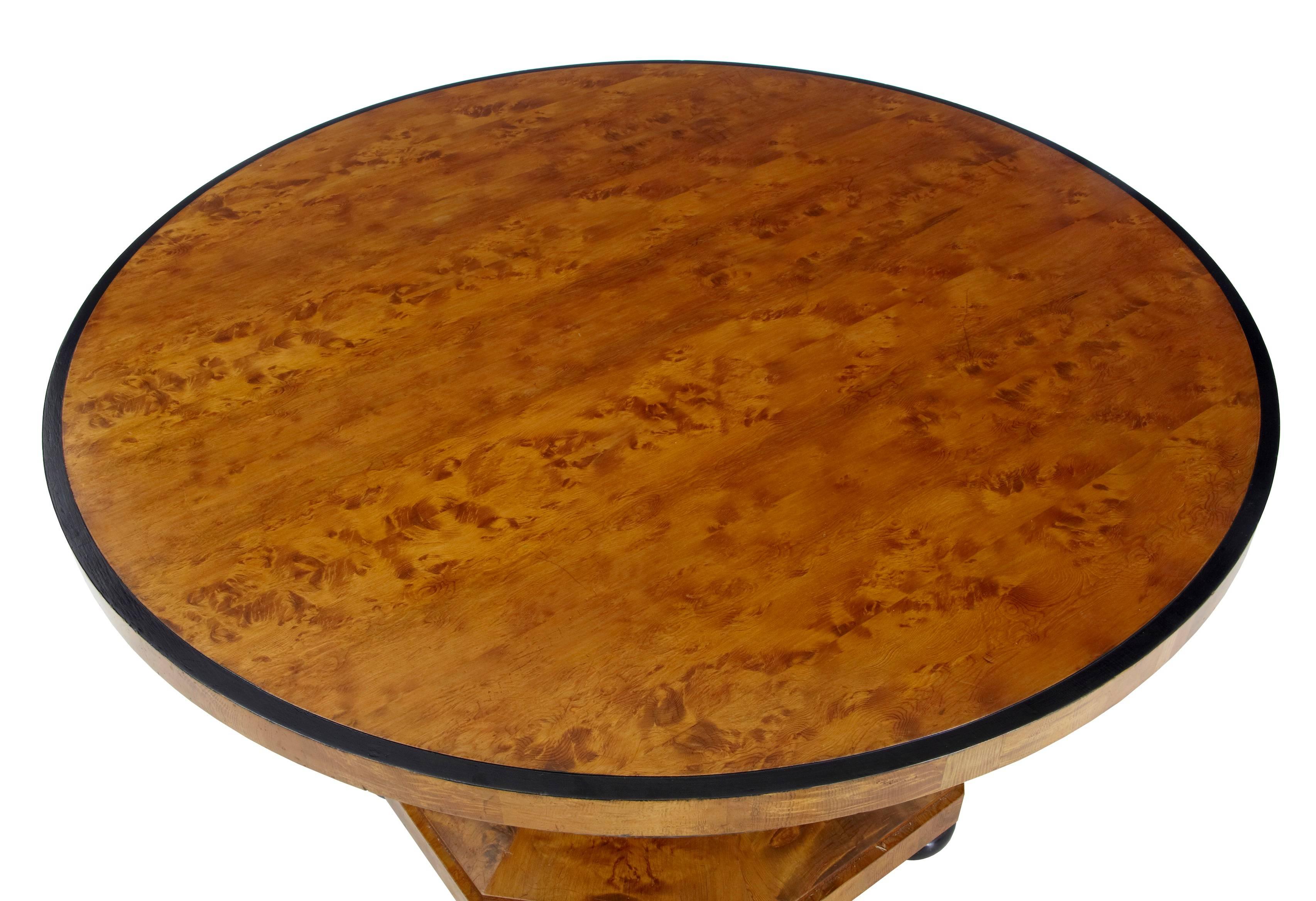 Good quality Art Deco period center or breakfast table, circa 1920.
Round pitch pine top with ebonized outer edge, below which a carved frieze.
Octagonal column with further ebonized stringing leads to an octagonal base. Standing on ebonized bun