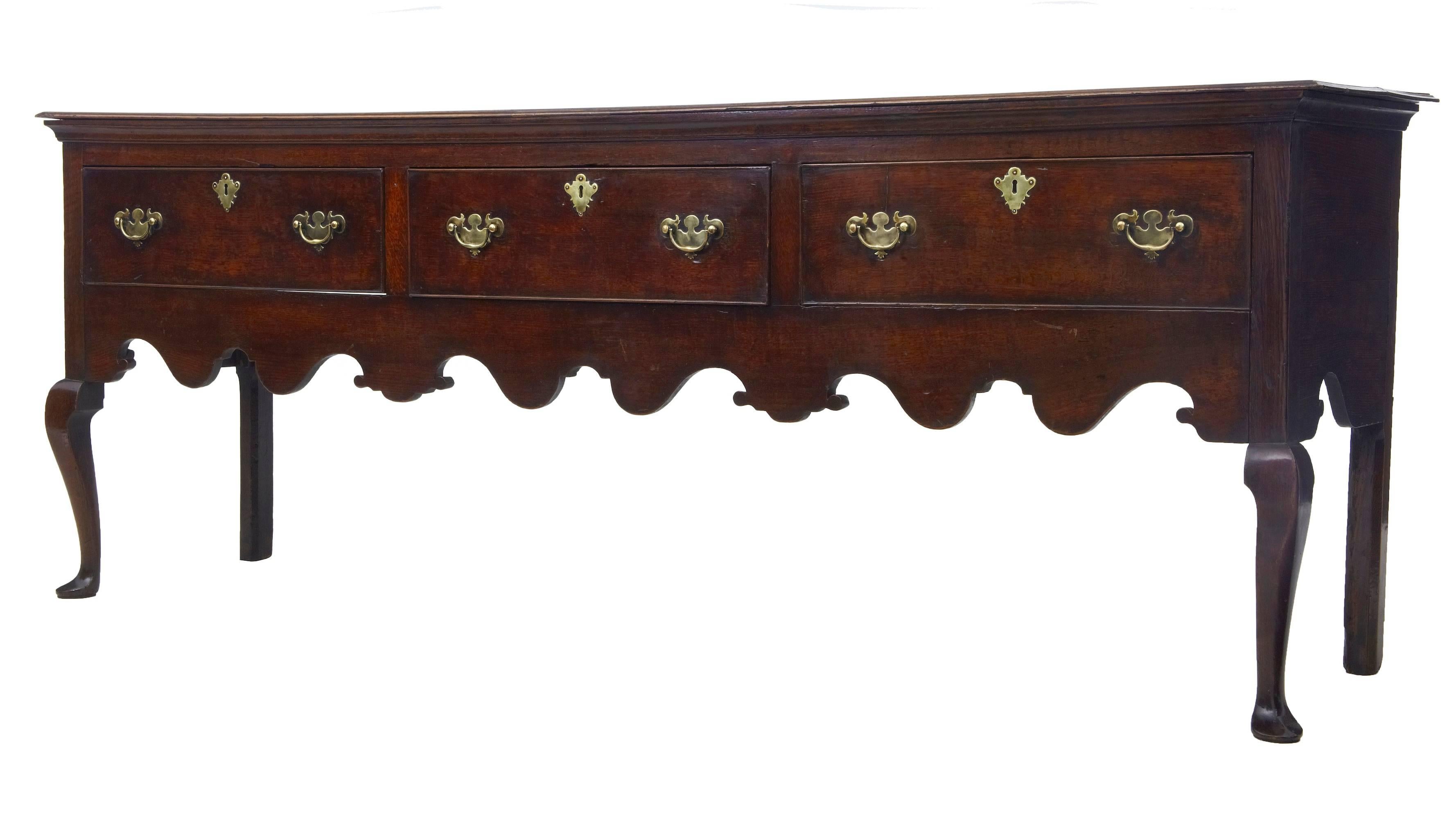 Good quality English dresser base in original condition, circa 1770.
Near 7 foot 6 inches in length.
Three large drawers to the front with cock beaded edging.
Of good color and patina.
Standing on front cabriole legs with pad feet.

Measures: