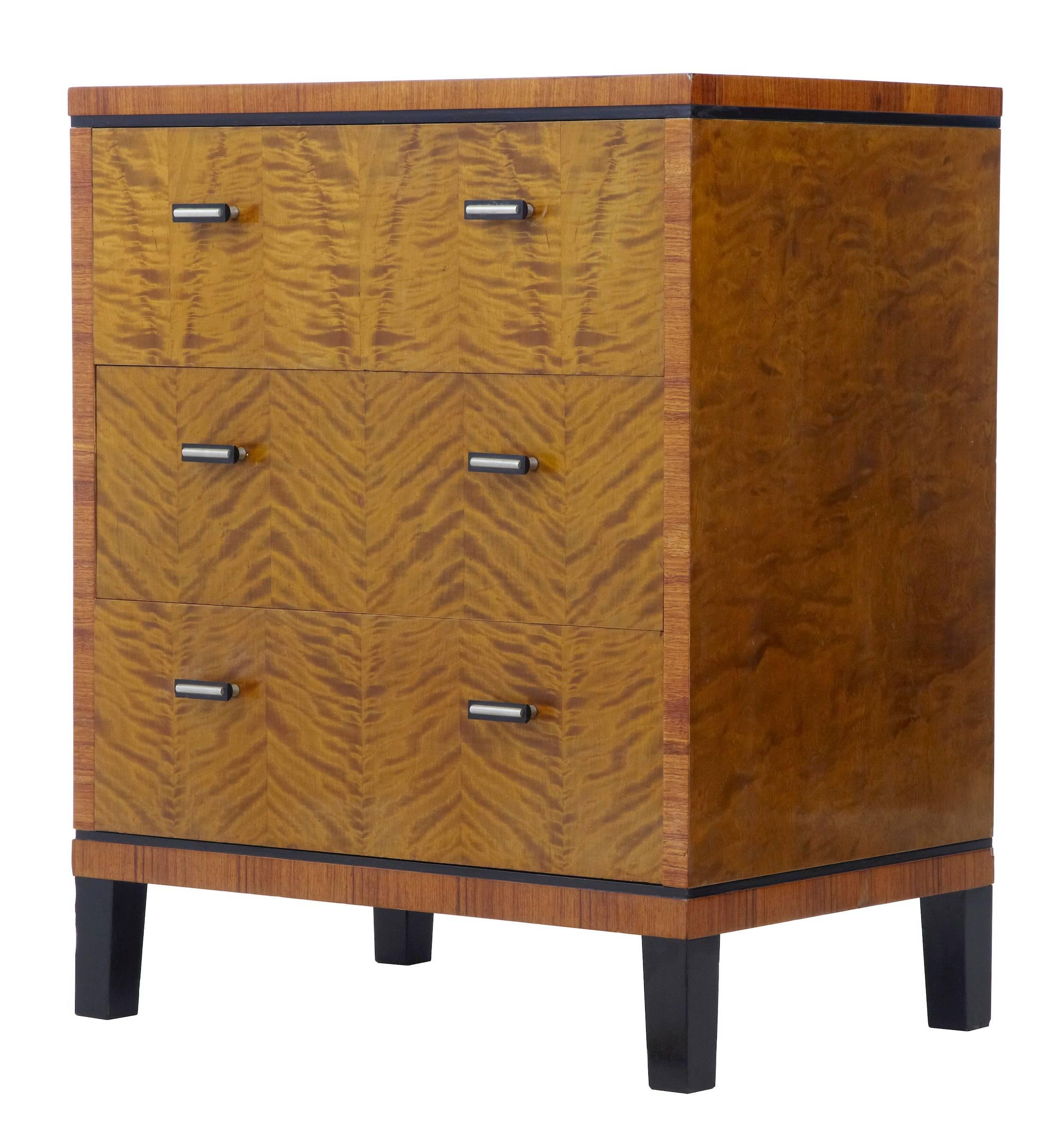 Three-drawer commode, circa 1950.
Rich birch color with ebonized banding and feet.
Minor veneer repairs.

Measures: Height: 31 1/2