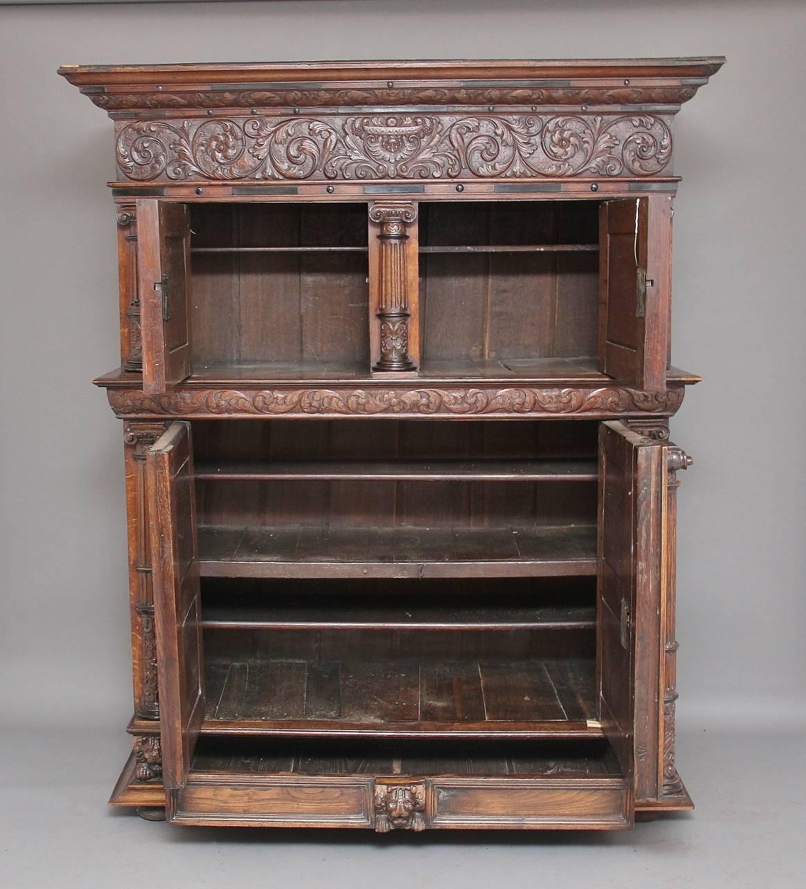 18th century carved Flemish oak cupboard.
A lovely quality early 18th century Flemish carved oak cupboard with two small doors above two large doors with a single drawer below, the top having a deep ogee moulded cornice with a frieze below which is