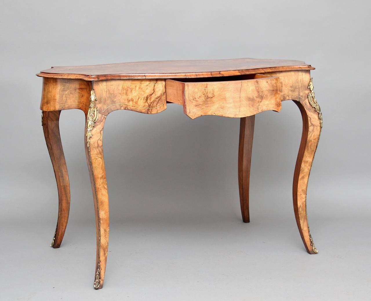 19th century inlaid walnut centre table, the top inlaid with floral marquetry with a thumb moulded edge, below with a nice shaped frieze with a single drawer at the front, standing on cabriole legs decorated with lovely quality brass mounts at the