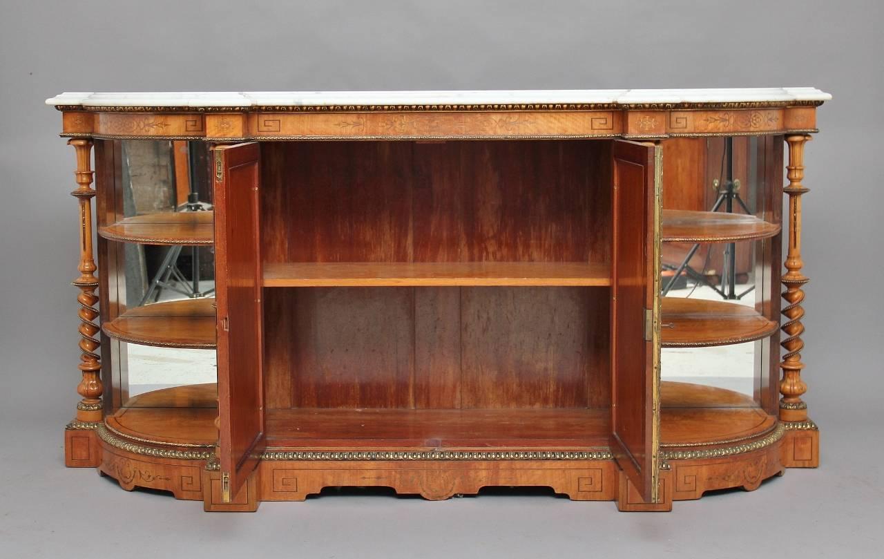 A superb exhibition quality 19th century satinwood and inlaid credenza, with the original shaped white marble top with a moulded edge, the frieze below decorated with lovely quality ormolu and inlaid in rosewood, with two cupboard doors below at the