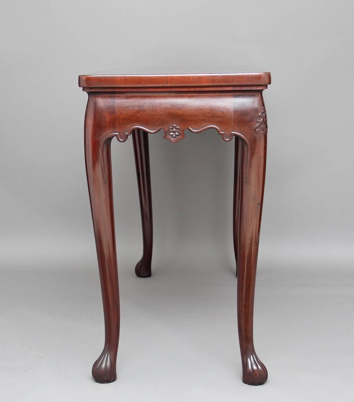 A freestanding 18th century mahogany serving or side table, possibly Irish with a bull nose moulded top, below along the front and sides having a nice beaded shaped apron with floral carved decoration, standing on lovely carved slender legs