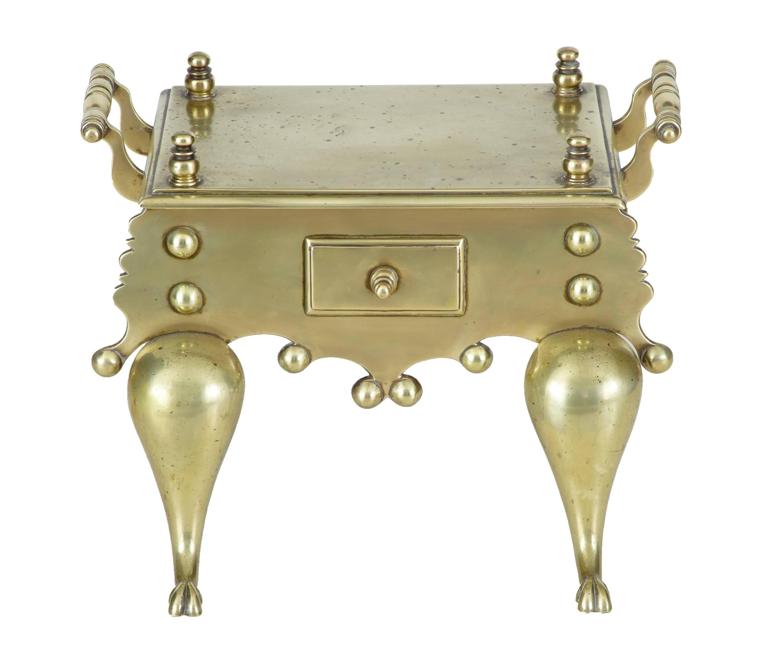 Excellent quality example of a brass and iron Victorian trivet / footman, circa 1860.
In good condition.

Turnings to the top which does have minor pitting. Handles to the side and a faux drawer to the front.
Standing on stylized paw