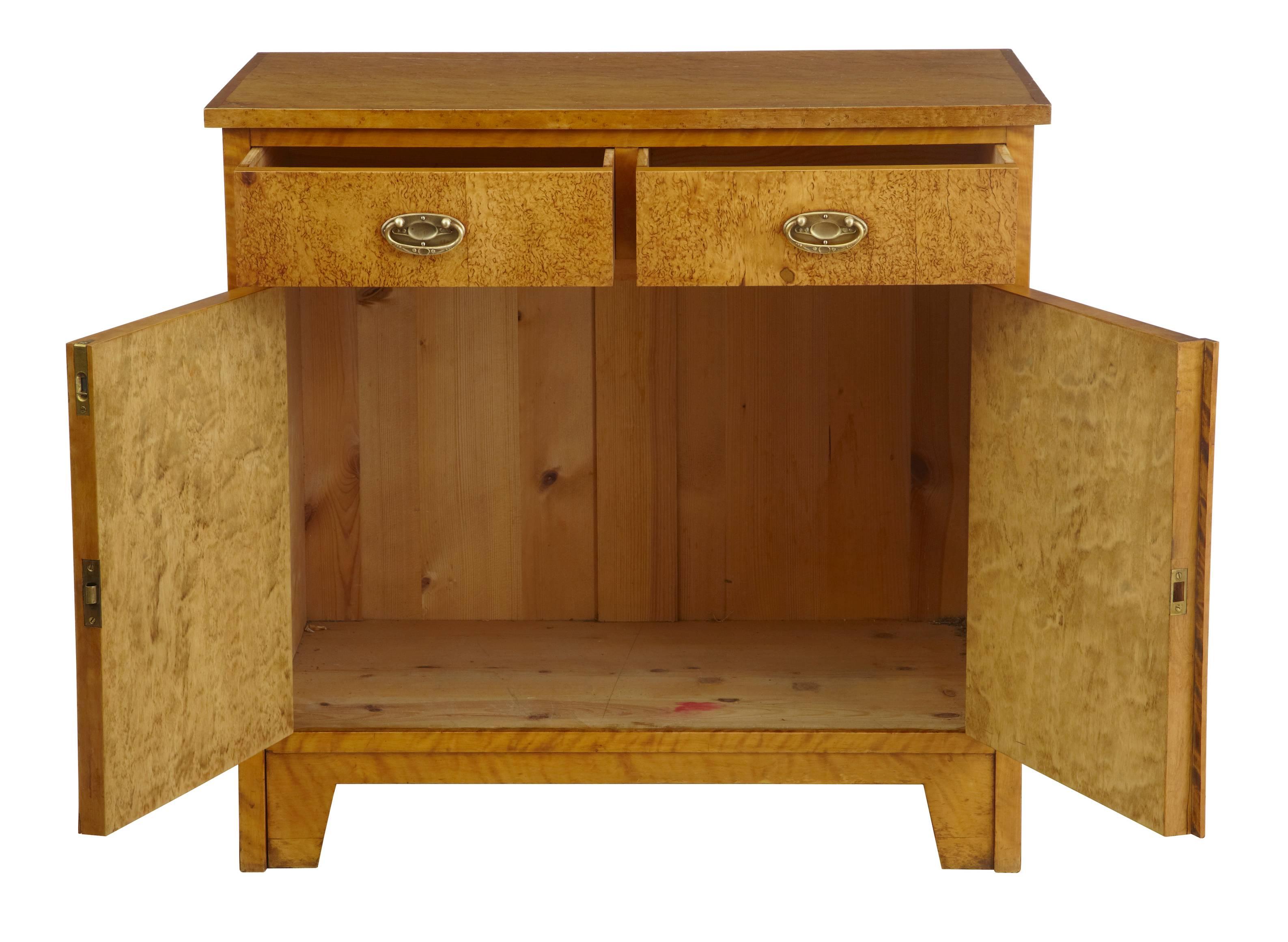 Good quality Swedish small cupboard with drawers, circa 1905.
Two drawers over double door cupboard.
Original handles.
Inlaid rose details to both door fronts.

Marks to top and one area of small fill.
Measures:
Height: 29 1/4