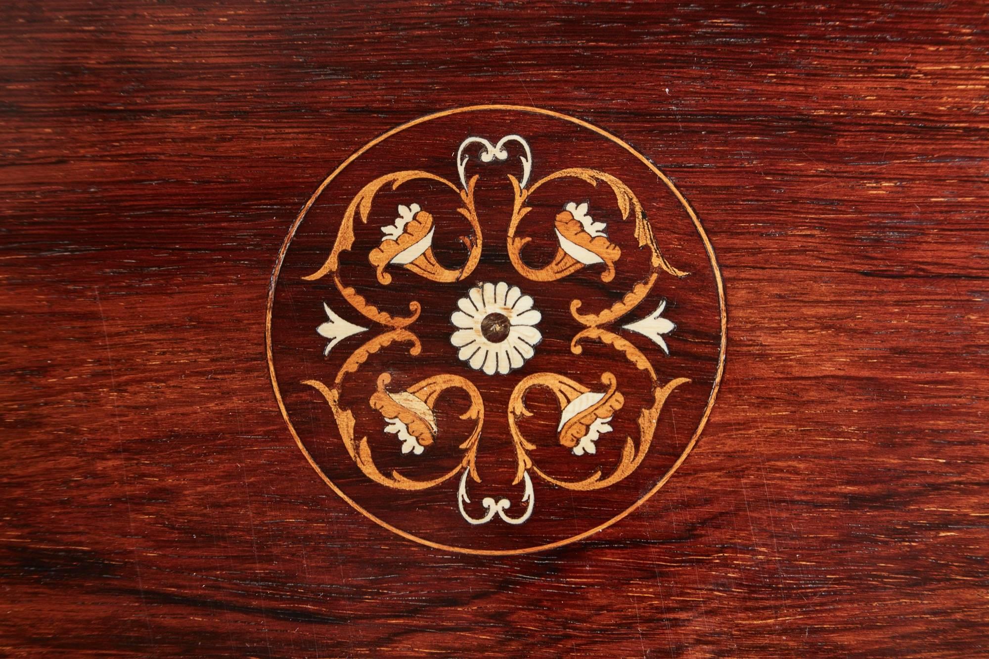 A quality inlaid freestanding rosewood occasional table, with bone and boxwood inlay to the shaped top, bone and boxwood inlaid shaped frieze, supported by four shaped legs with bone and boxwood inlay, shaped inlaid under-tier, original