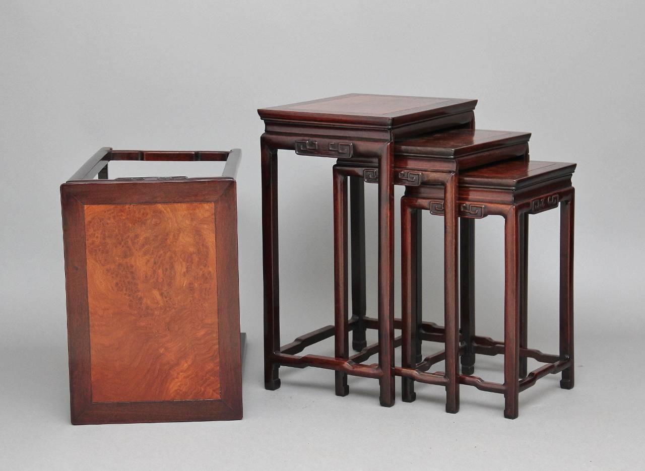 19th century Chinese rosewood nest of four tables with burr elm tops, having raised decoration to the friezes on slender square supports united by stretchers, circa 1880.

Height: 26
