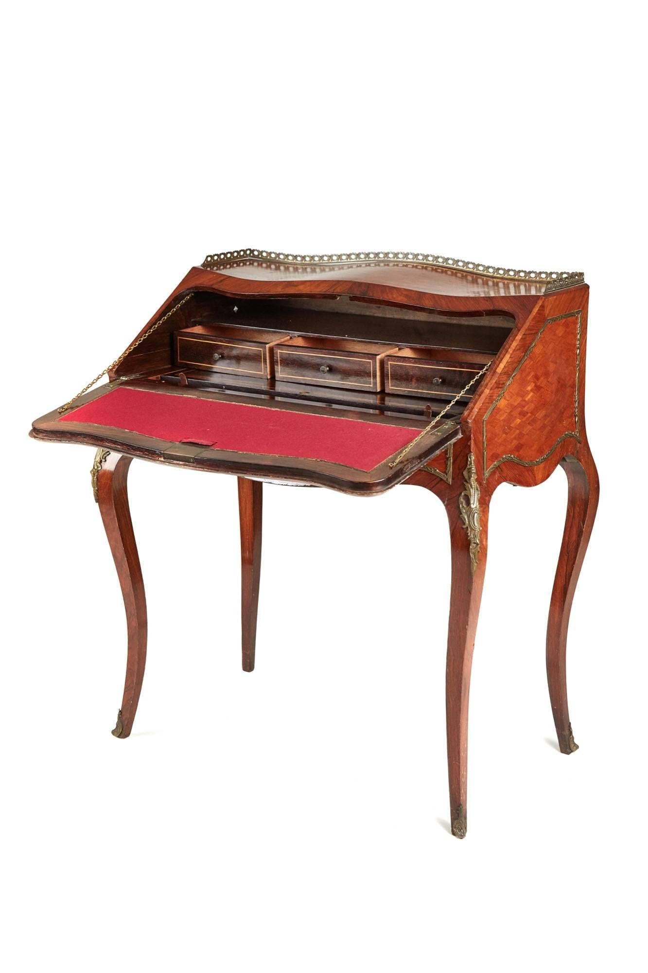 A French kingwood and parquetry bureau de dame, with a shaped parquetry top original gilt metal gallery, shaped parquetry ends with gilt metal mounts, lovely shaped vernis martin painted fall crossbanded in kingwood, the inside has a writing surface