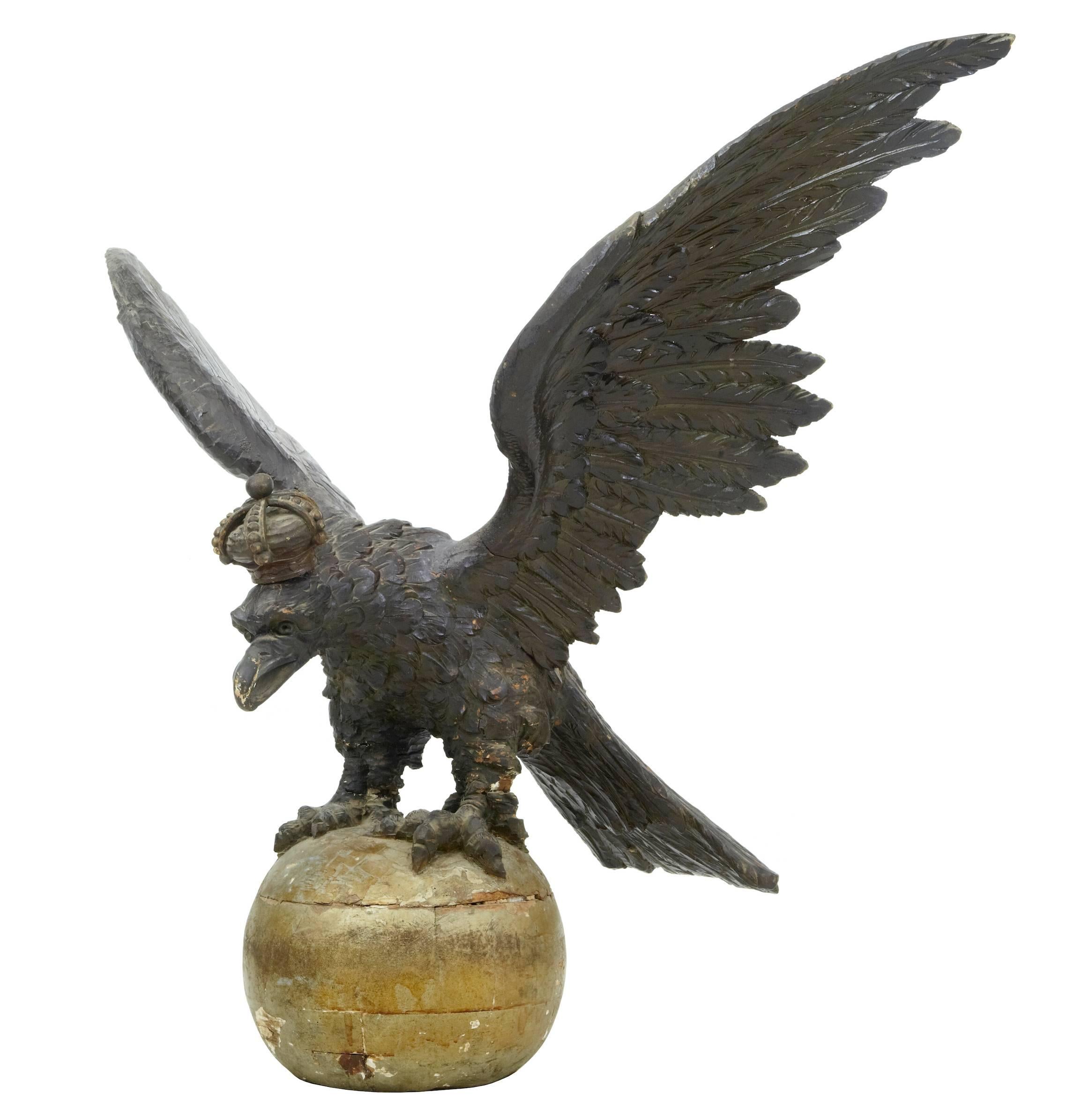 Stunning carved German Hapsburg eagle standing on gilt wood ball, circa 1820.
Profusely carved in linden wood and in near original condition.
In good solid condition.
Some minor restorations and age splits.
One loss to rear feather