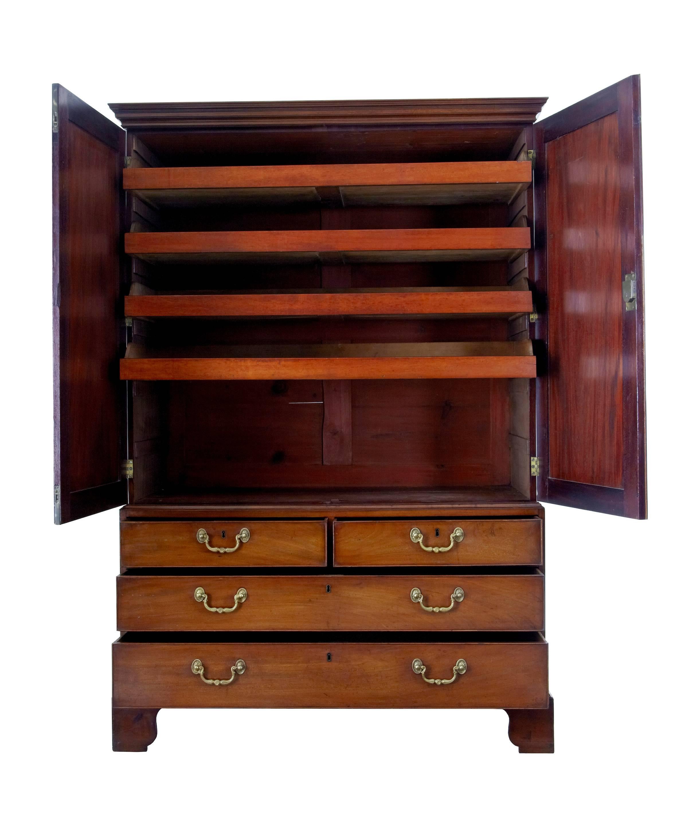 Late Georgian linen press, circa 1810.
Comprising of three parts, removable plinth, top section and base.
Double doors open to four sliding drawers, one of which is missing.
Bottom section of two over two drawers.
Standing on bracket feet.
Some