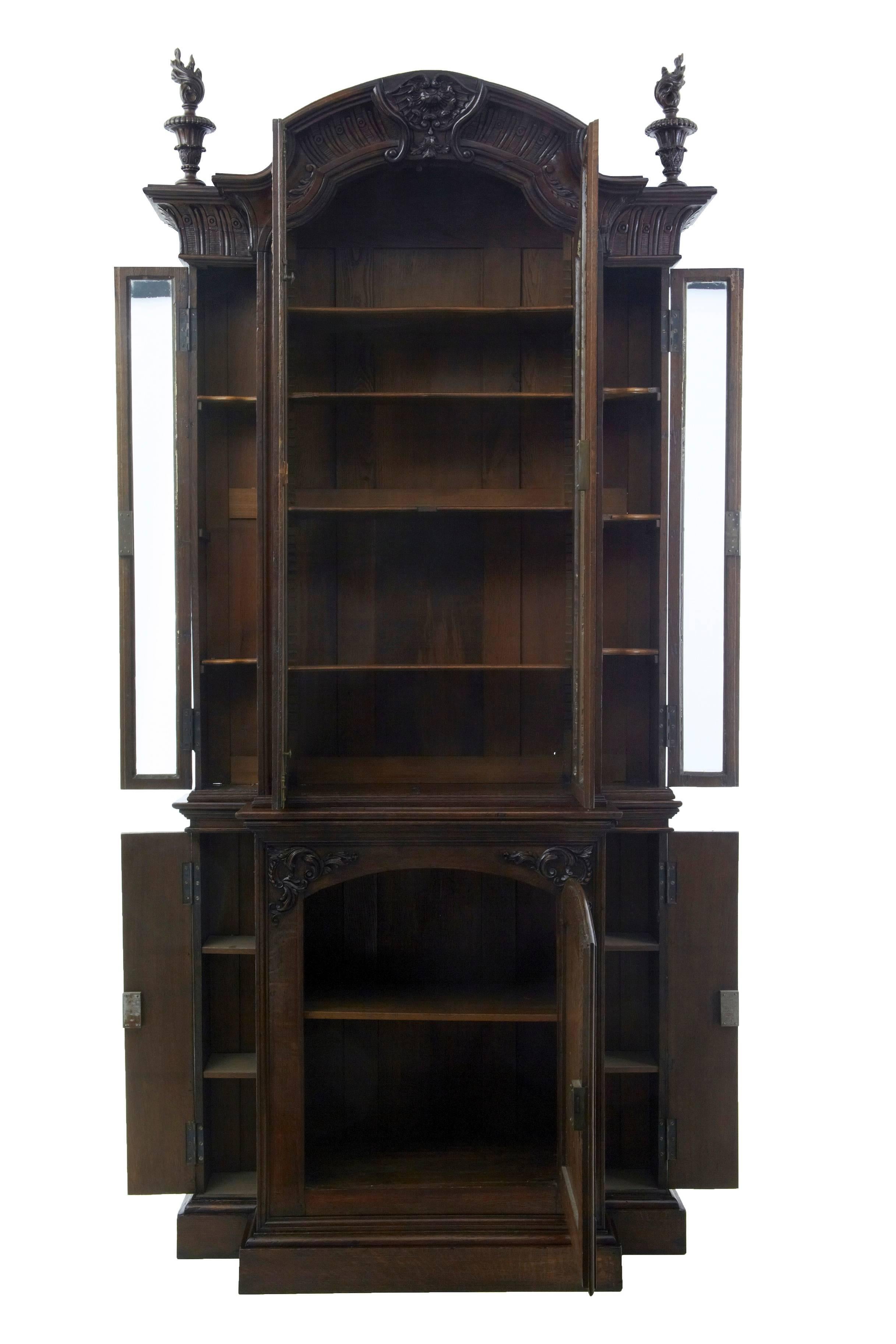 Here we have a fine matched pair of break front bookcase cabinets, circa 1850.
Each cabinet comprising of two parts with removable carved finials.
These bookcases were obviously made by the same maker. There is slight differences in proportions,