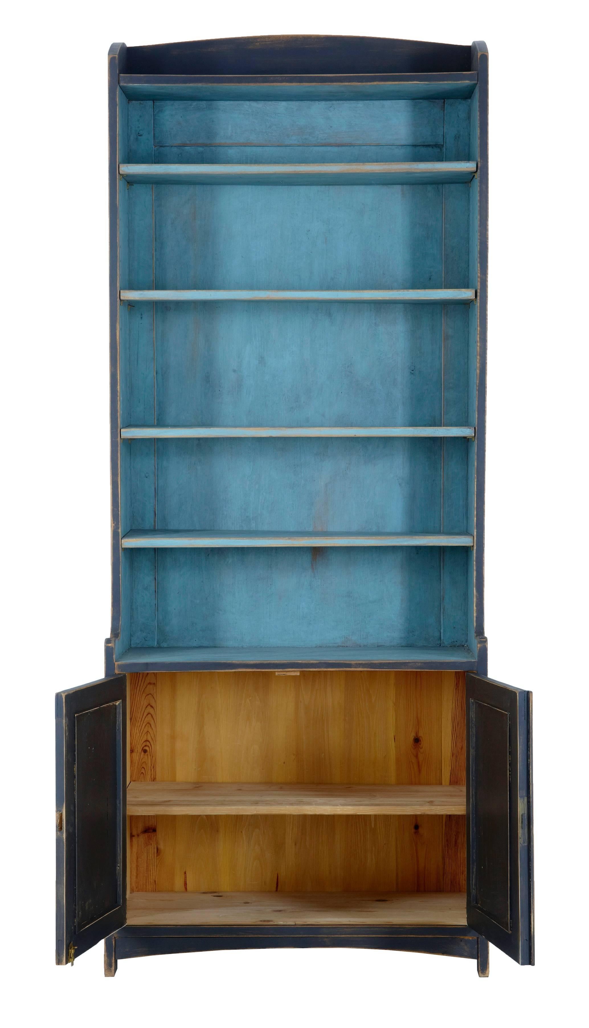 One piece Swedish bookcase cupboard, circa 1880.
Beautifully decorated in later paint, charcoal grey with contrasting blue shelves.
Double door cupboard opens to reveal bare pine interior.

Measures: Height: 77
