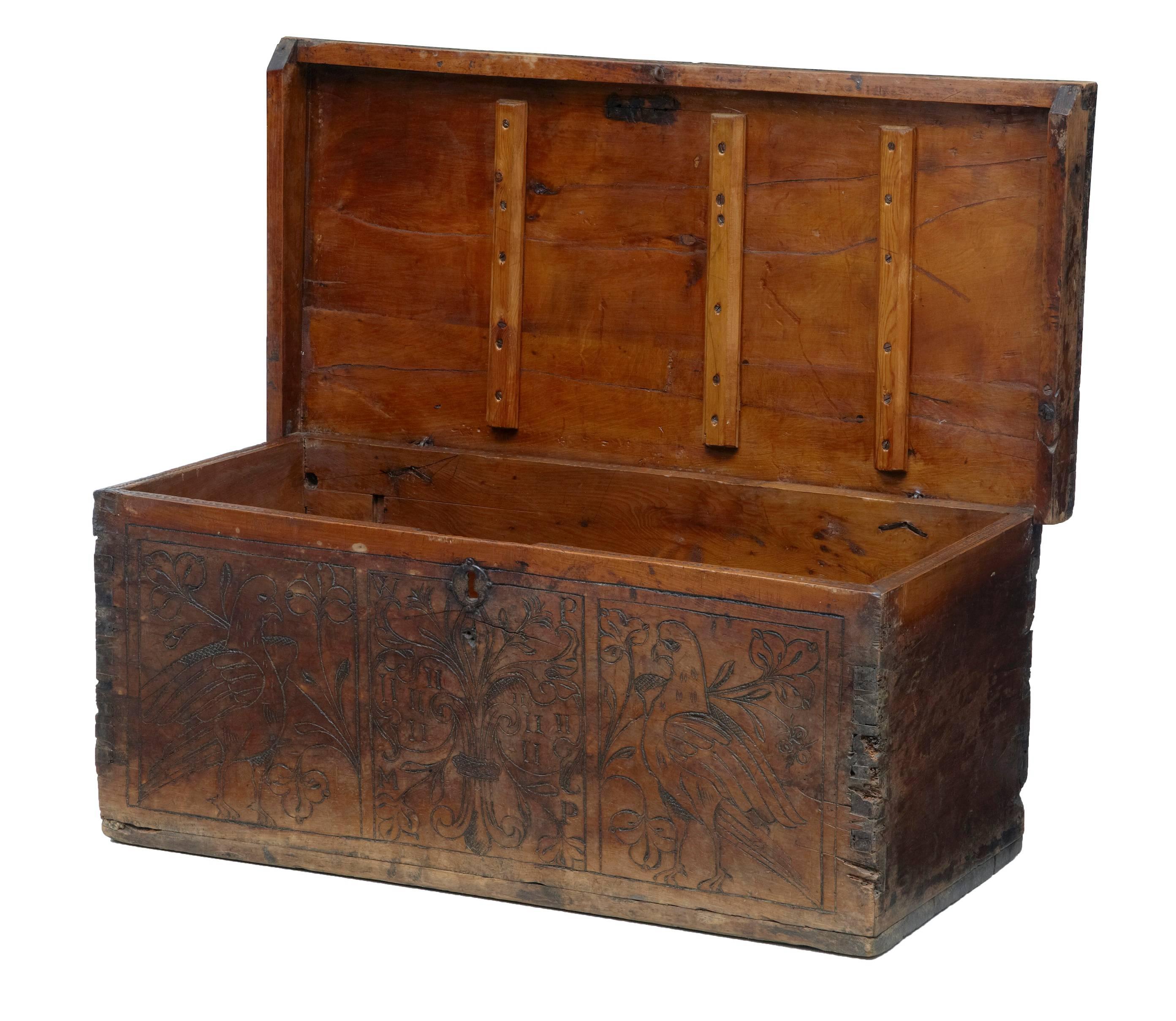 Small walnut marriage chest, circa 1700.
Poker work on the front with initials in a fleur de lys design, flanked either side by doves.
No lock present.
Top with extensive restorations, hard wax to age splits to top and later woodwork supports on
