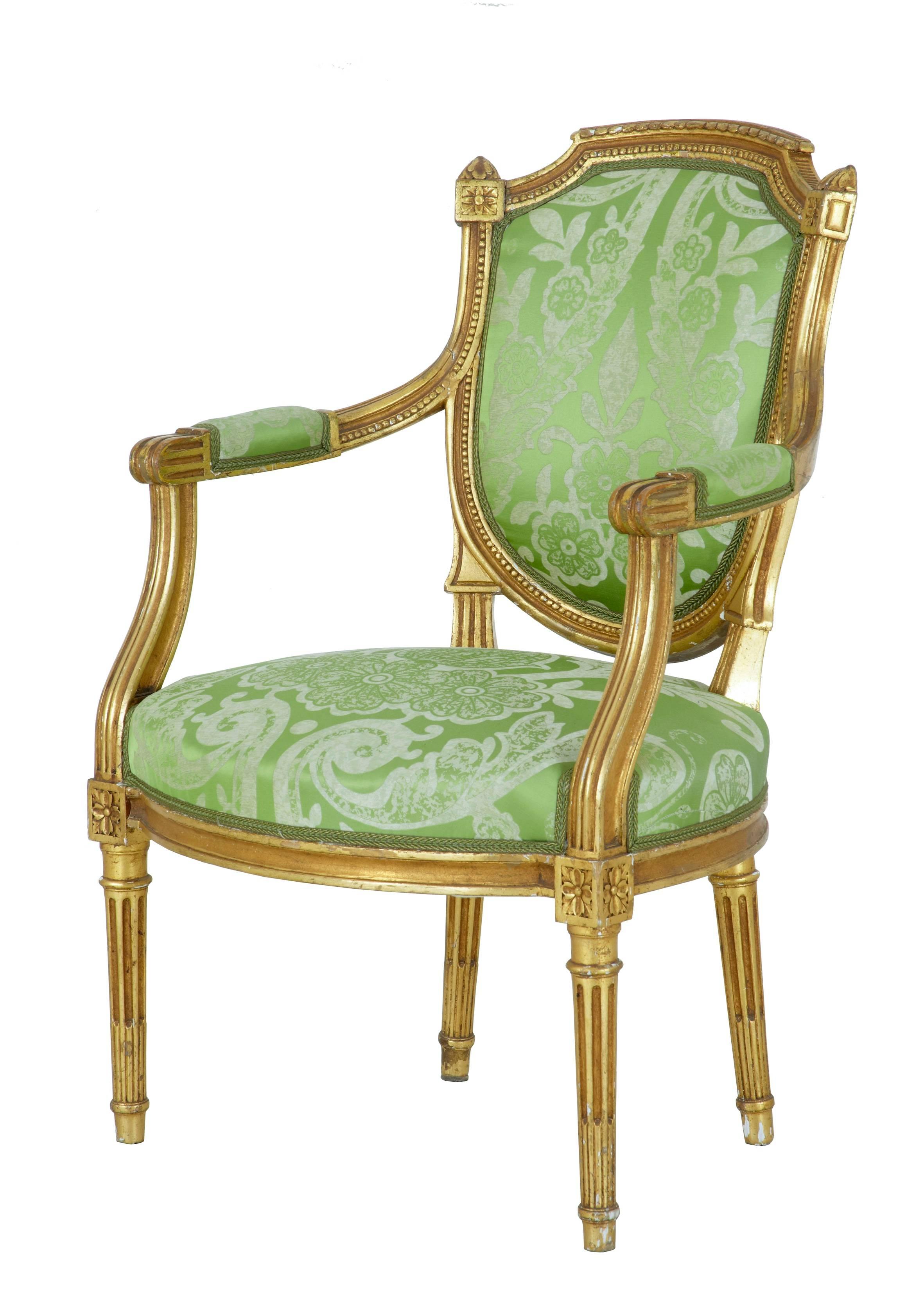 Fine set of French gilt armchairs, circa 1880.
Shaped shield back rests, over stuffed seats, standing on channelled legs.
Upholstered in striking two-tone green material, which is in good order.
Minor gilt and gesso losses.

Measures: Height: