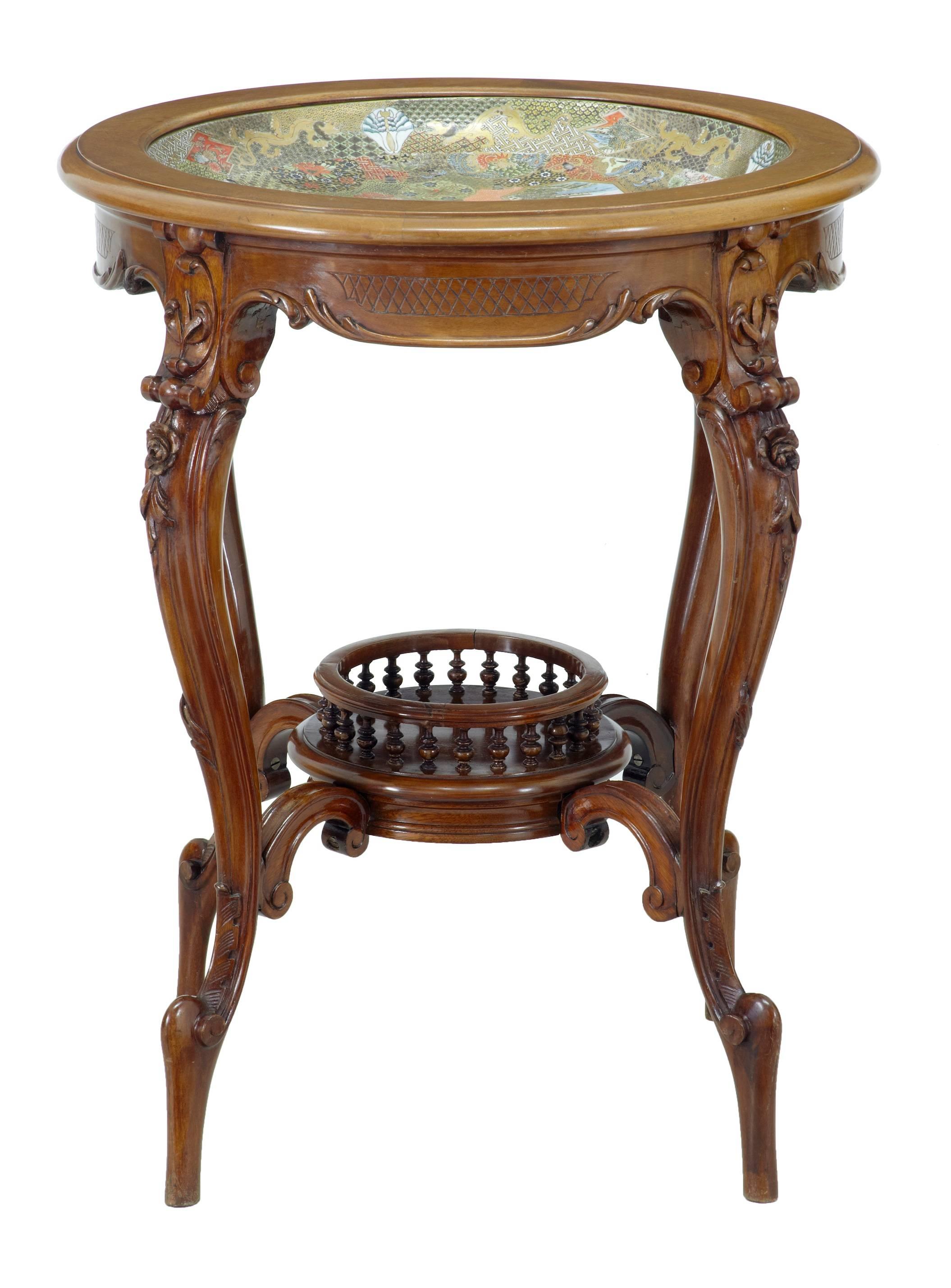 Japanese carved occasional table, circa 1900.
Features a large satsuma bowl inset into the top.
Carved shaped legs which are united by a central spindle display level.
Highly polished finish.
Measures: Height: 28 3/4